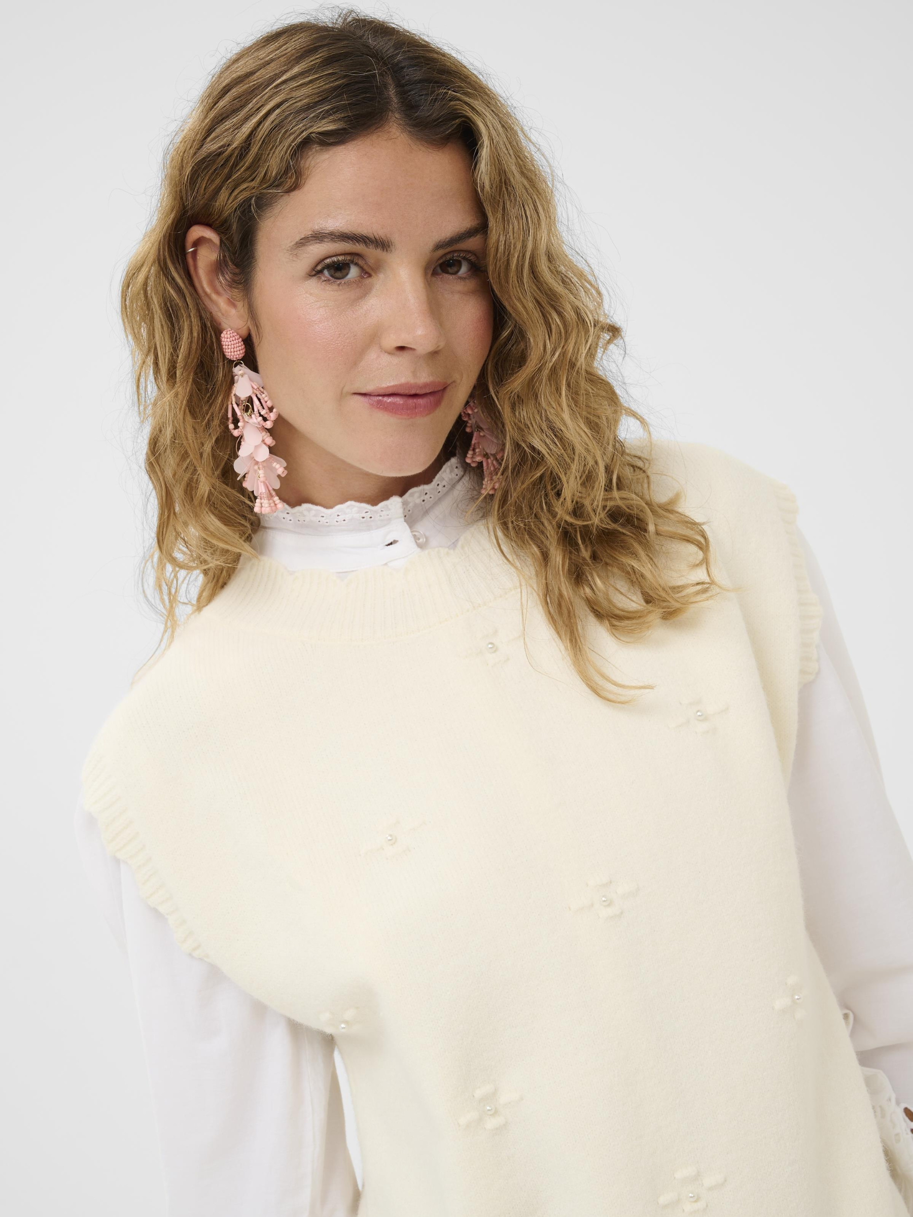 Cream Avie Knit Slipover women’s loose-fit hip-length sleeveless knit with soft textured fabric.