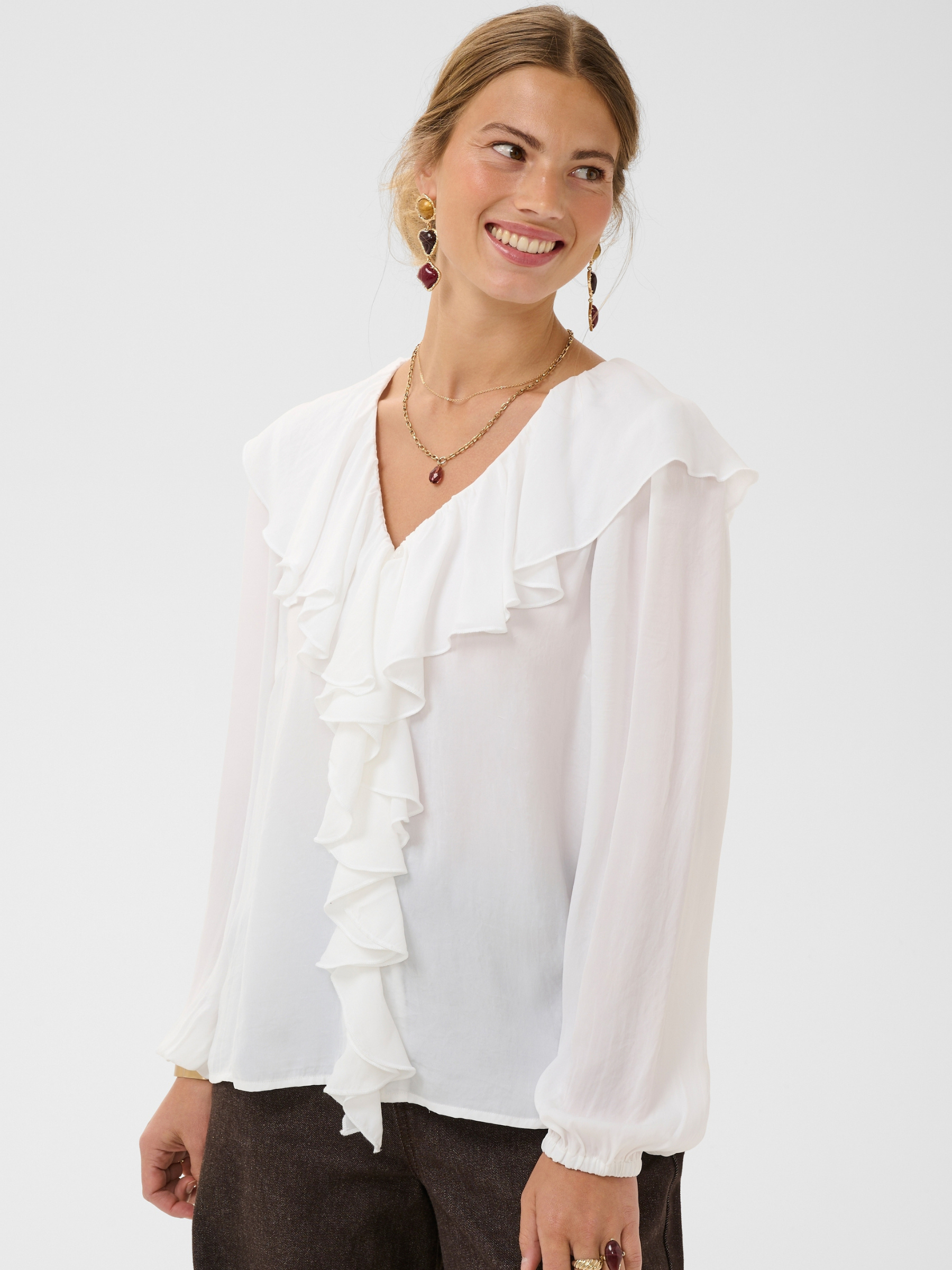 Cream Beliv Blouse with ruffle front detailing and long sleeves in a lightweight fabric.
