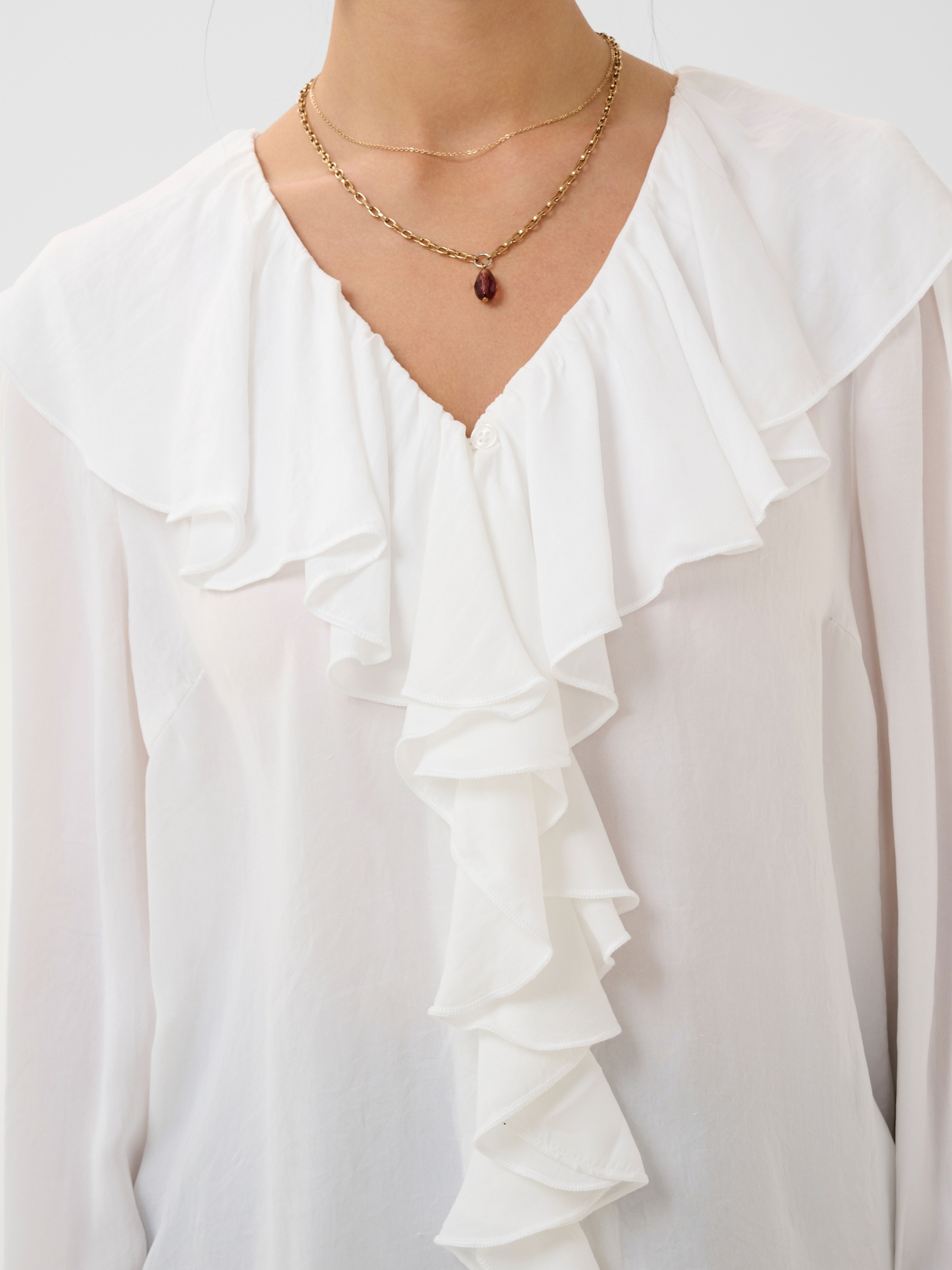 Cream Beliv Blouse with ruffle front detailing and long sleeves in a lightweight fabric.