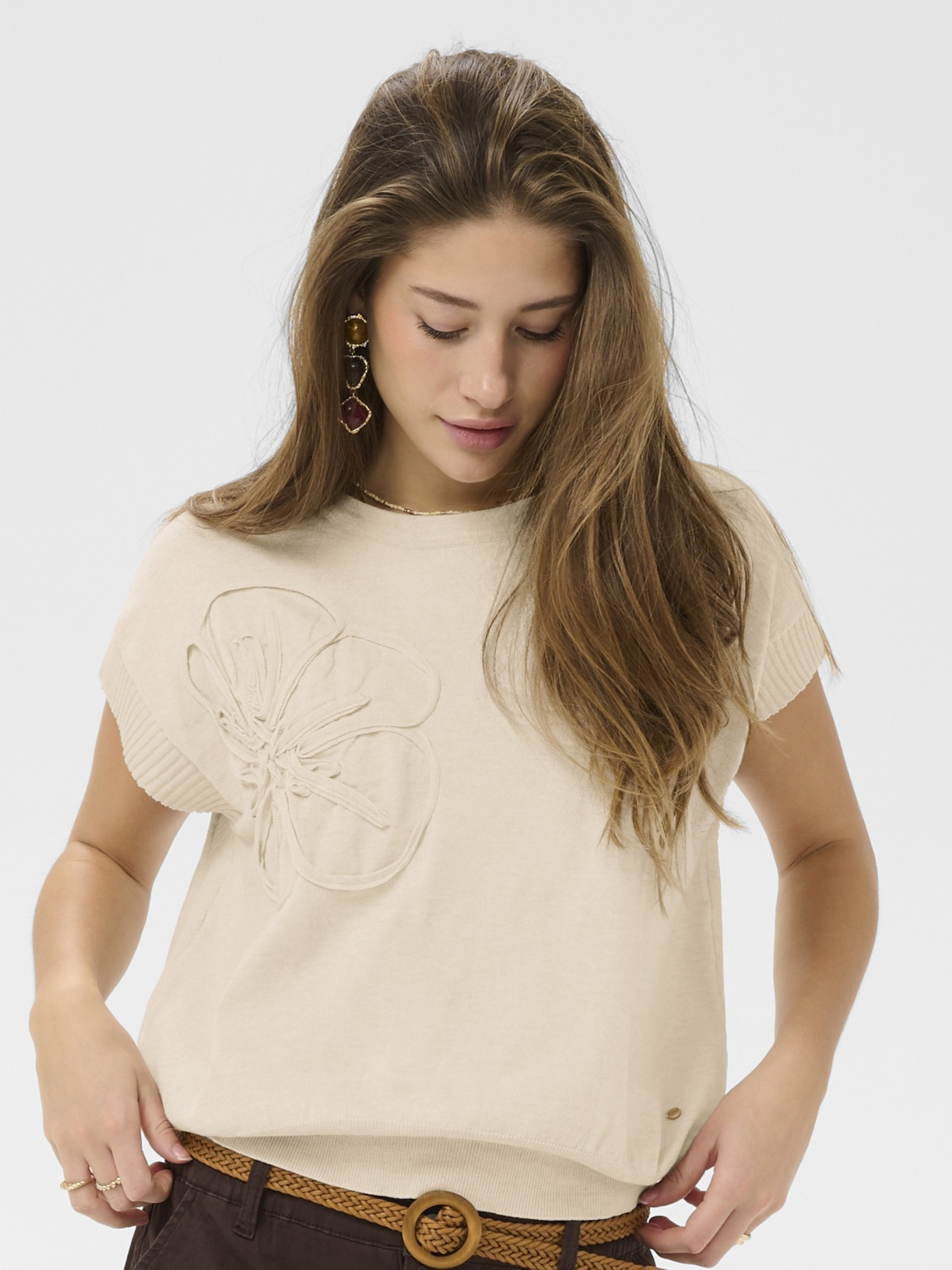 Cream Dela Knit With Deco Slipover lightweight knit top with floral applique detail and short sleeves.