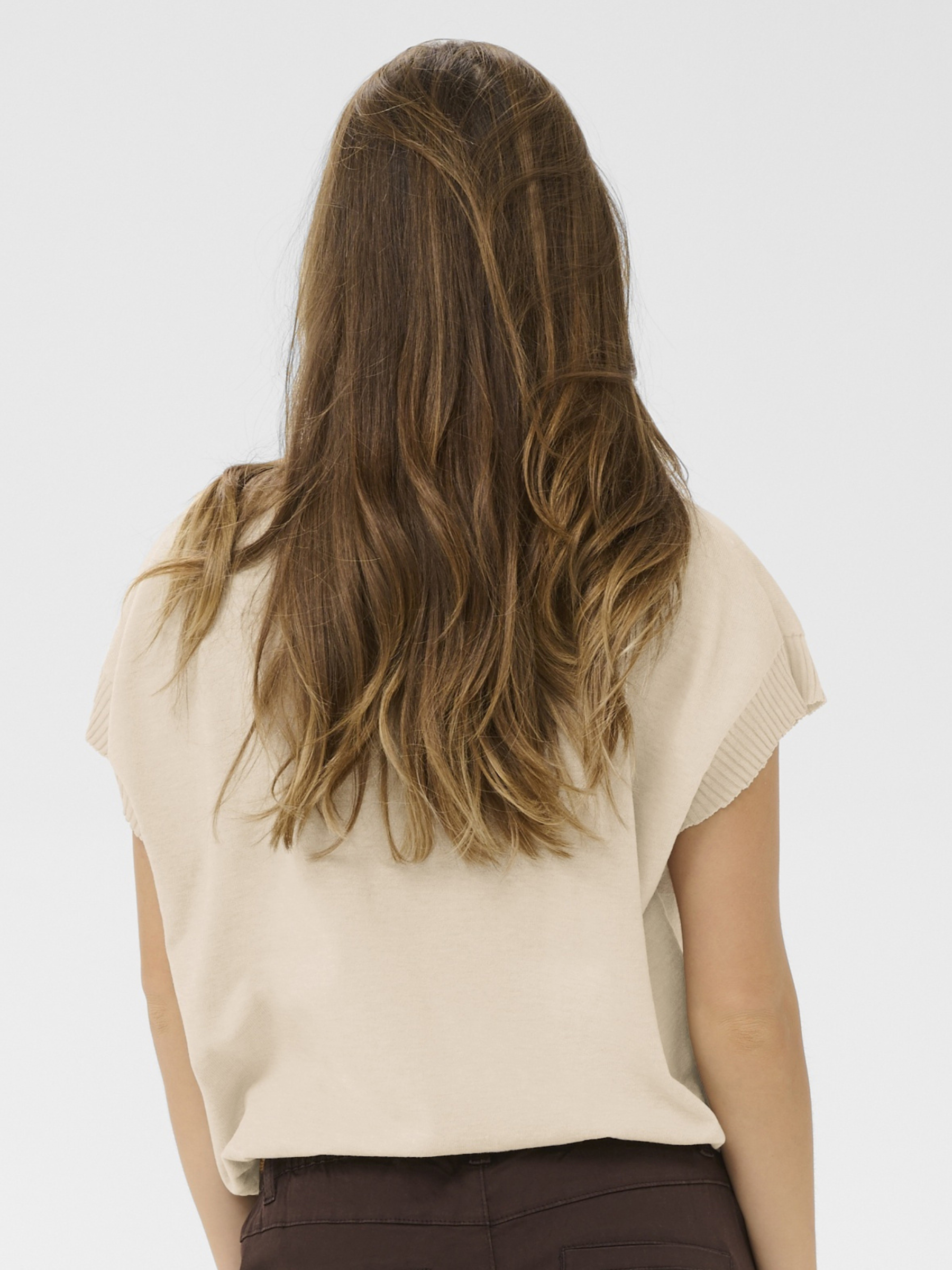 Cream Dela Knit With Deco Slipover lightweight knit top with floral applique detail and short sleeves.