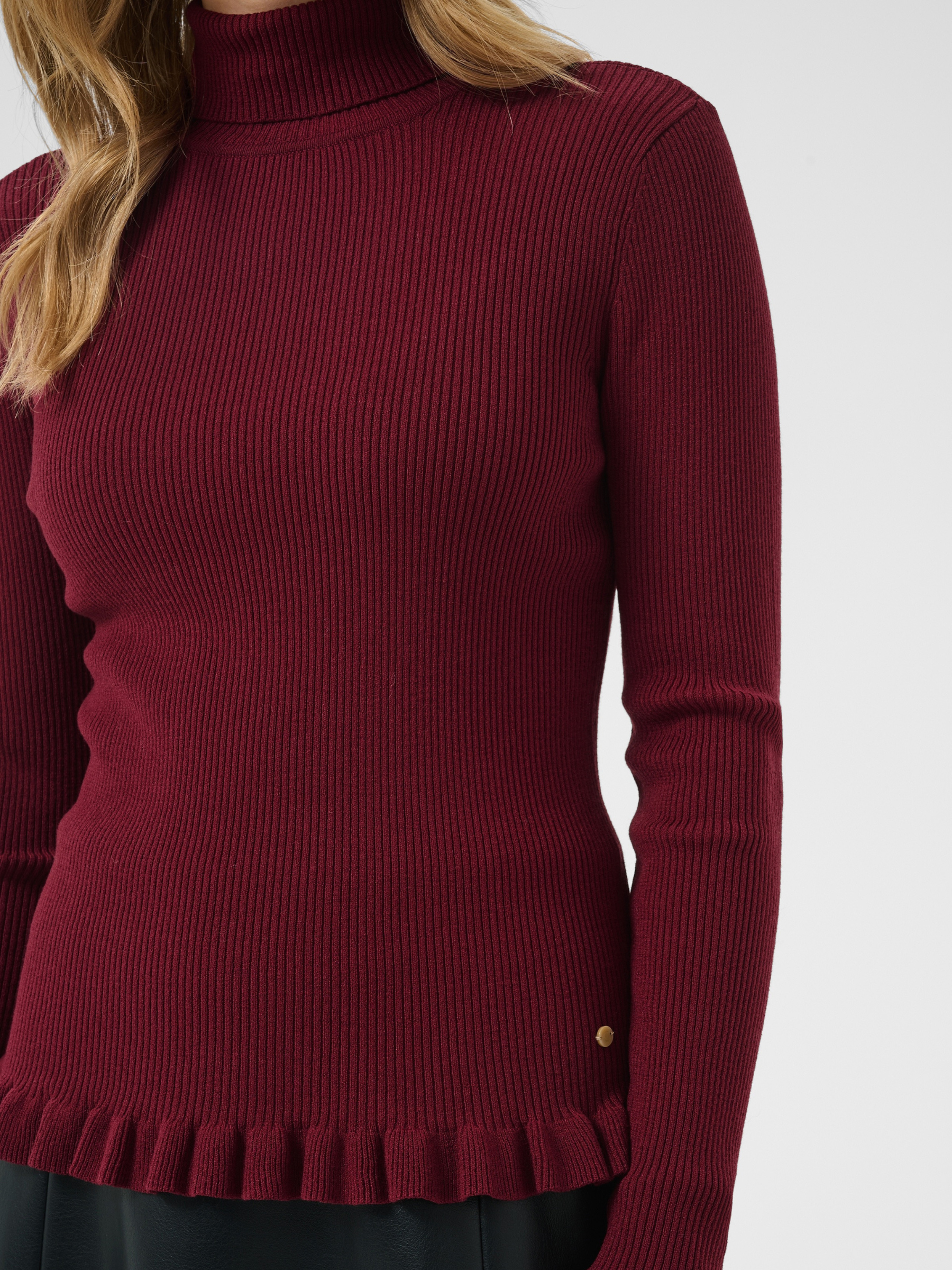 Cream Dela Roll Neck Knit with ribbed texture, roll neck, long sleeves, frill cuffs and hip-length fit