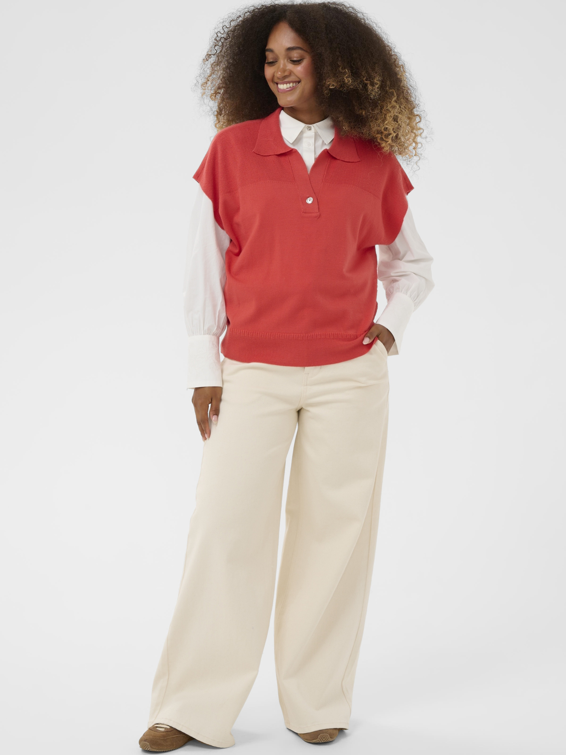 Cream Dela Slipover women’s relaxed fit knitted slipover with sleeveless design and hip-length cut, styled layered over a shirt.