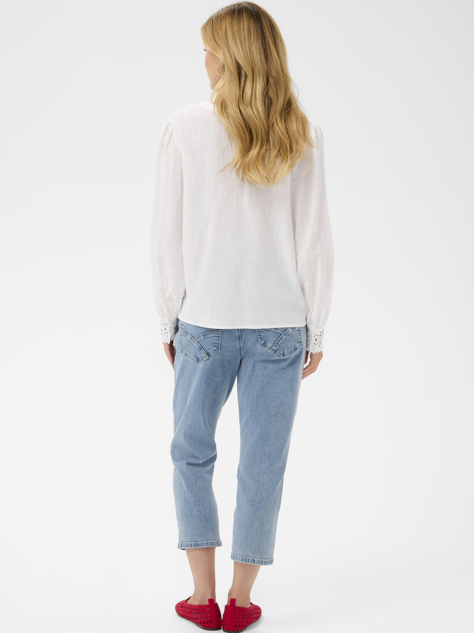 Cream Delia white V-neck blouse with long sleeves and lace cuff detailing in lightweight cotton.