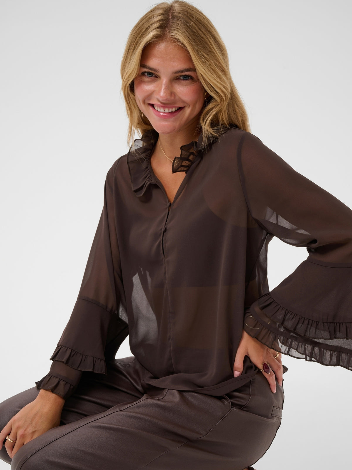 Cream Flouncy Blouse with ruffle neckline, button front and layered flared sleeves.