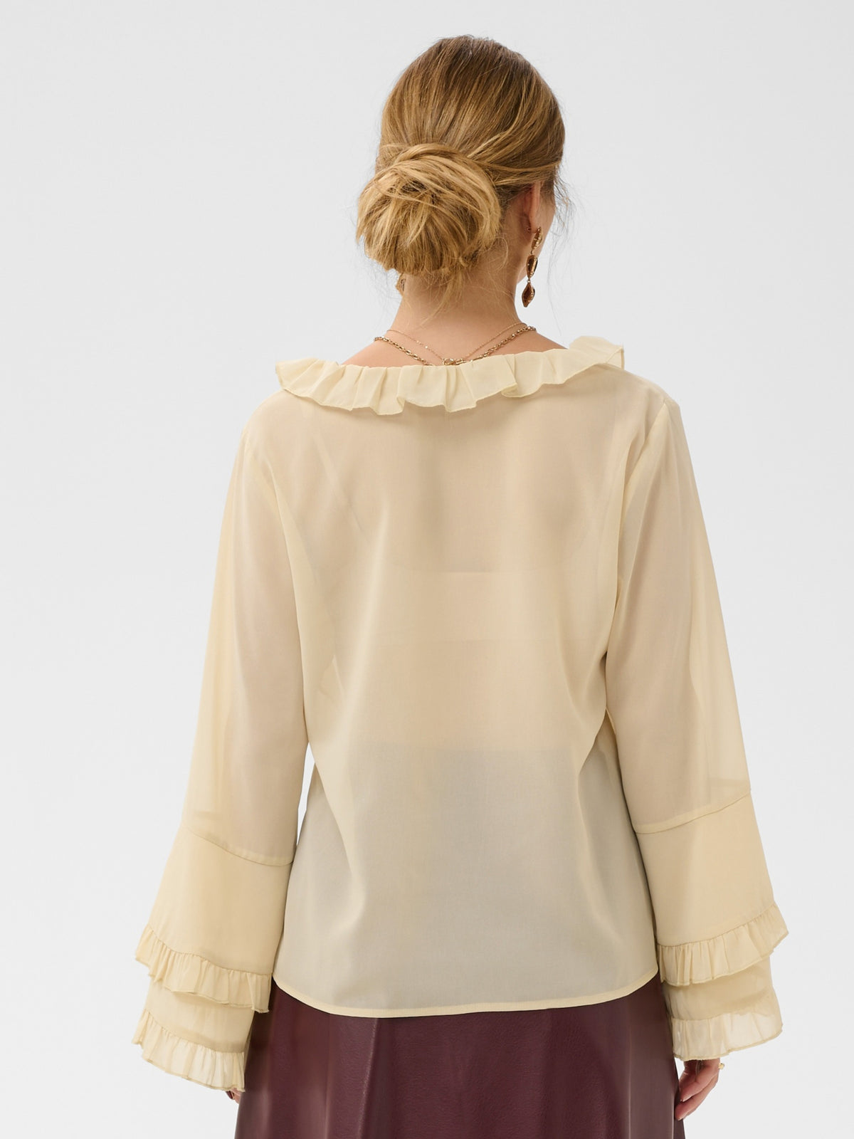 Cream Flouncy Blouse with ruffle neckline, button front and layered flared sleeves.