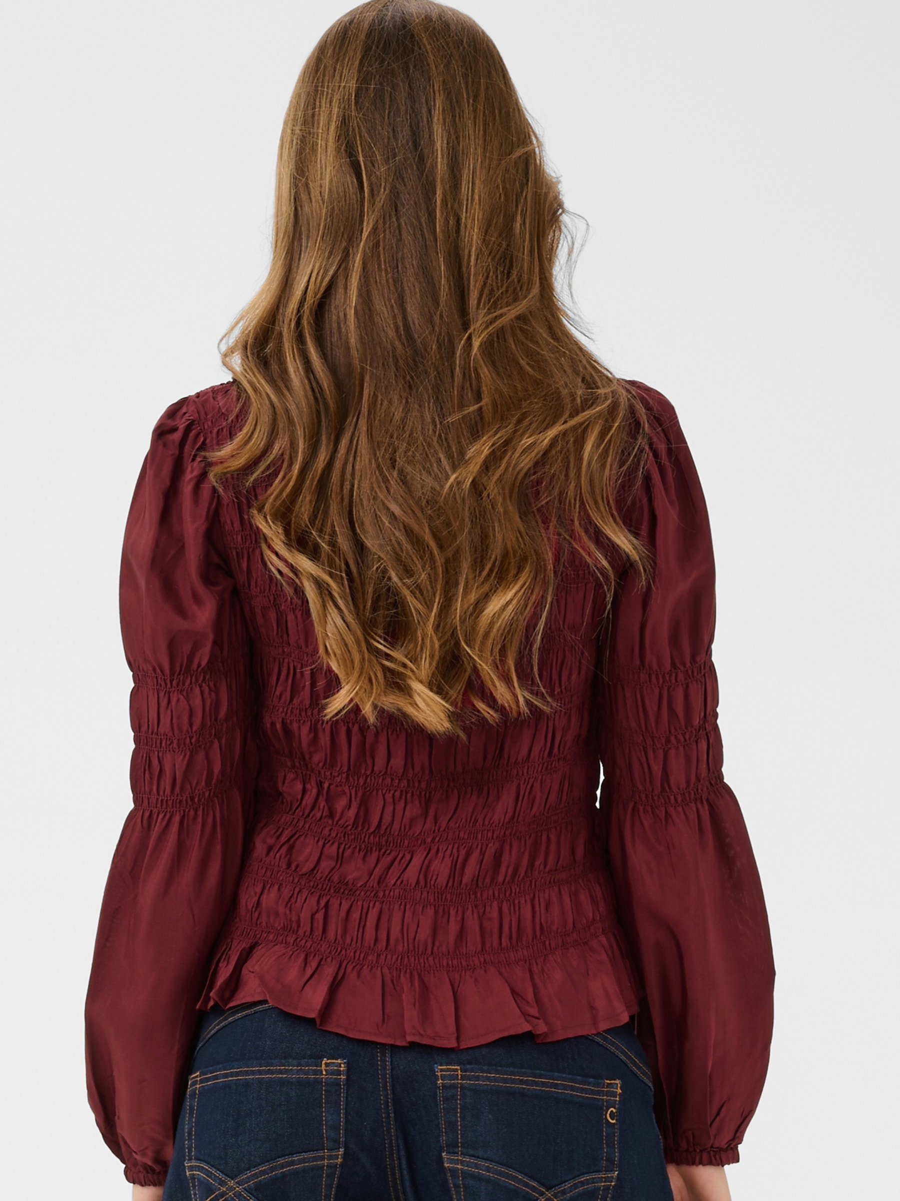 Cream Henva Blouse with shirred texture design and frill hem.