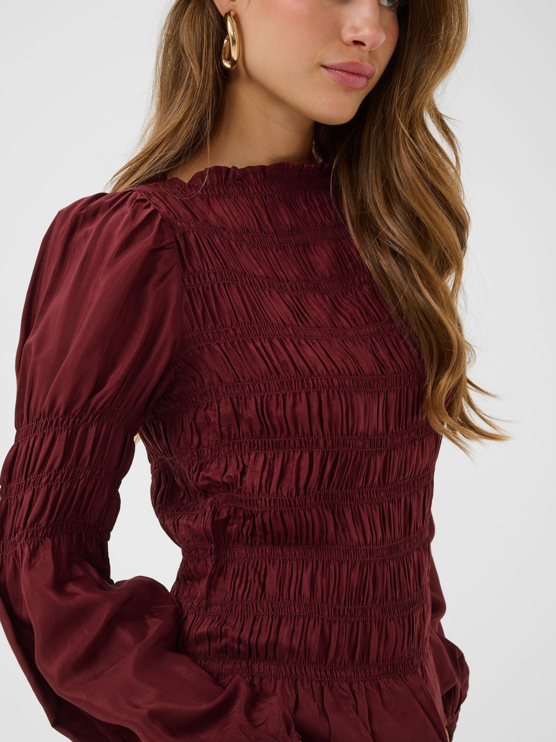 Cream Henva Blouse with shirred texture design and frill hem.