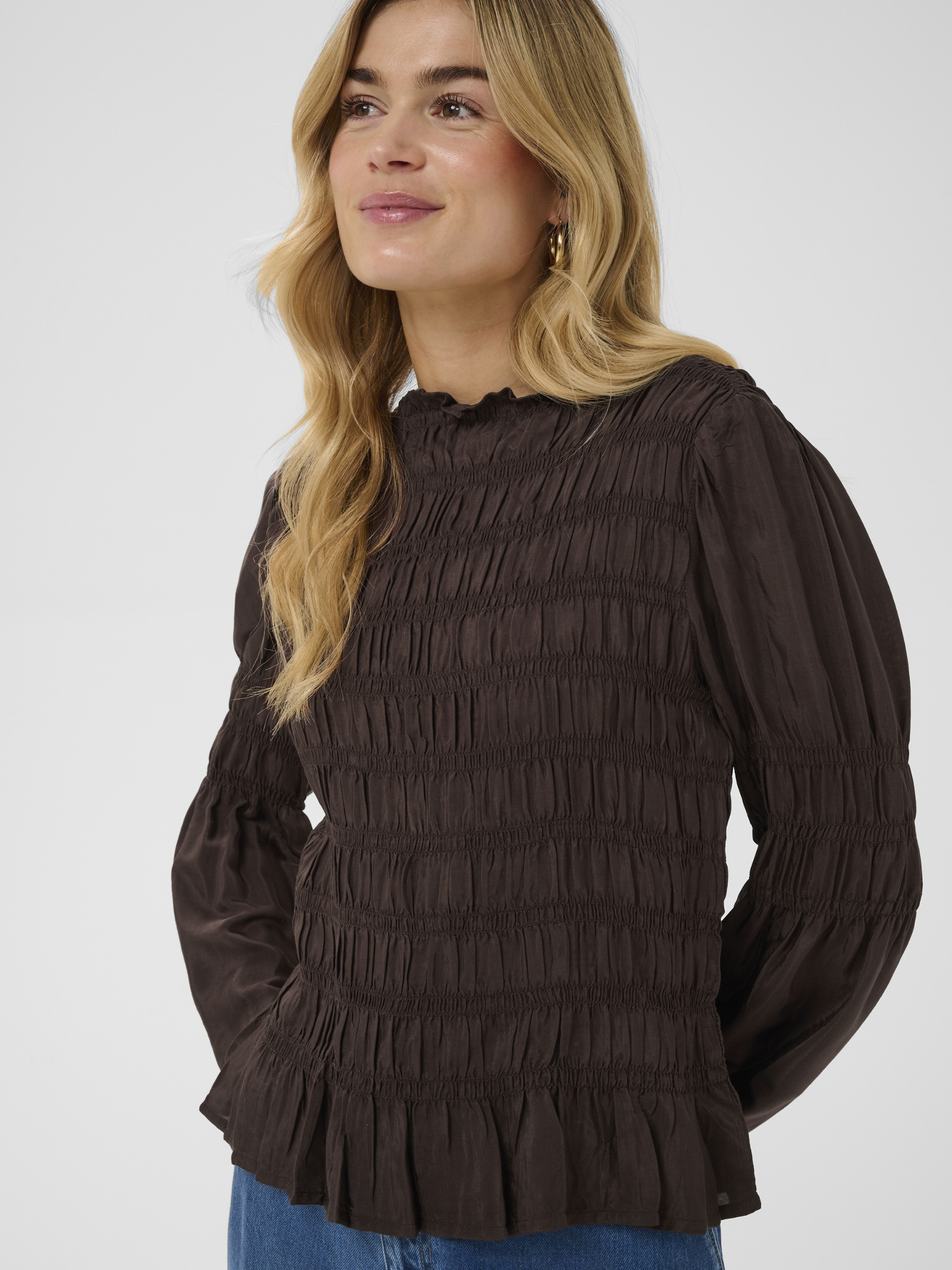 Cream Henva Blouse with shirred texture design and frill hem.