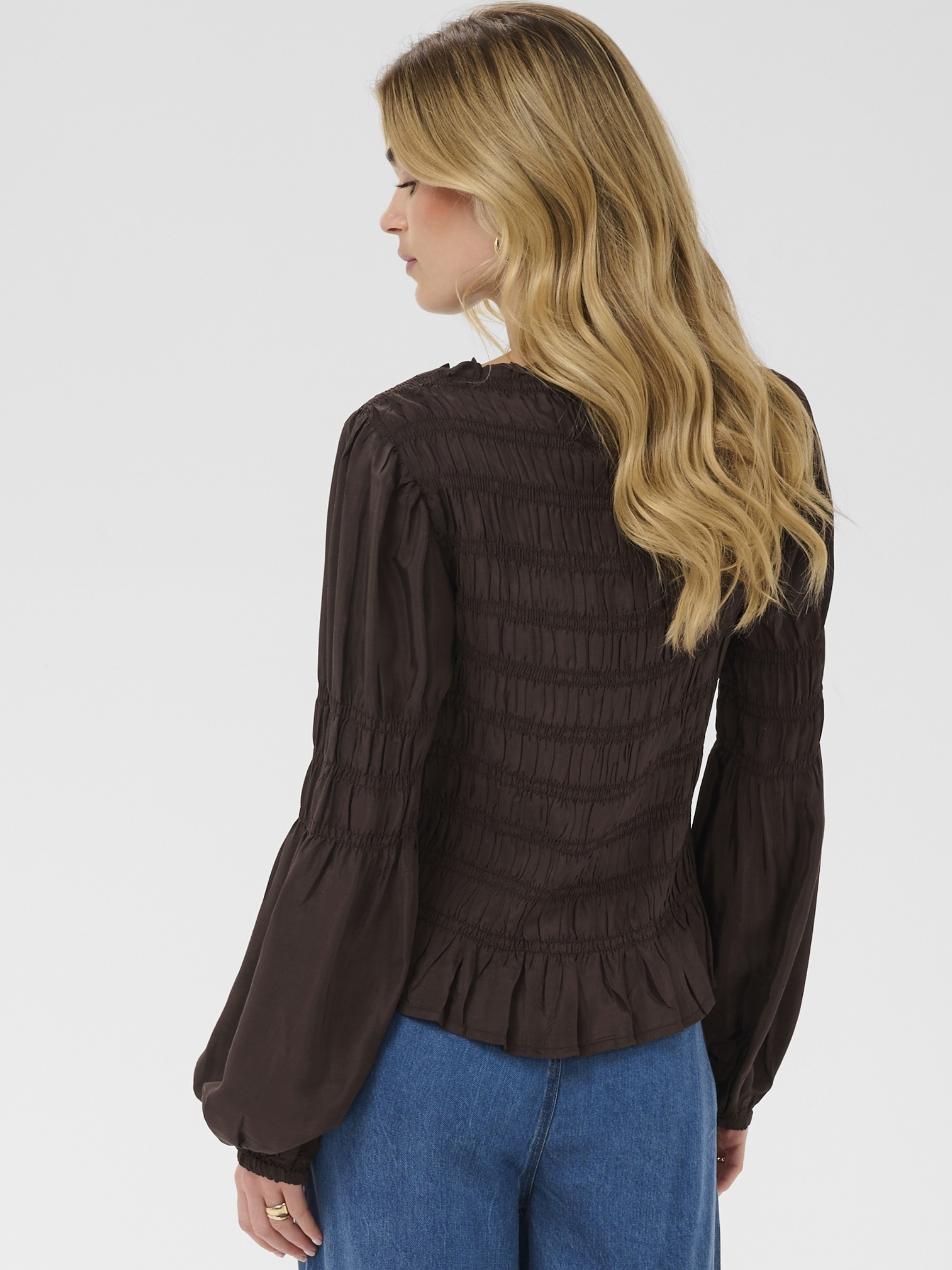 Cream Henva Blouse with shirred texture design and frill hem.