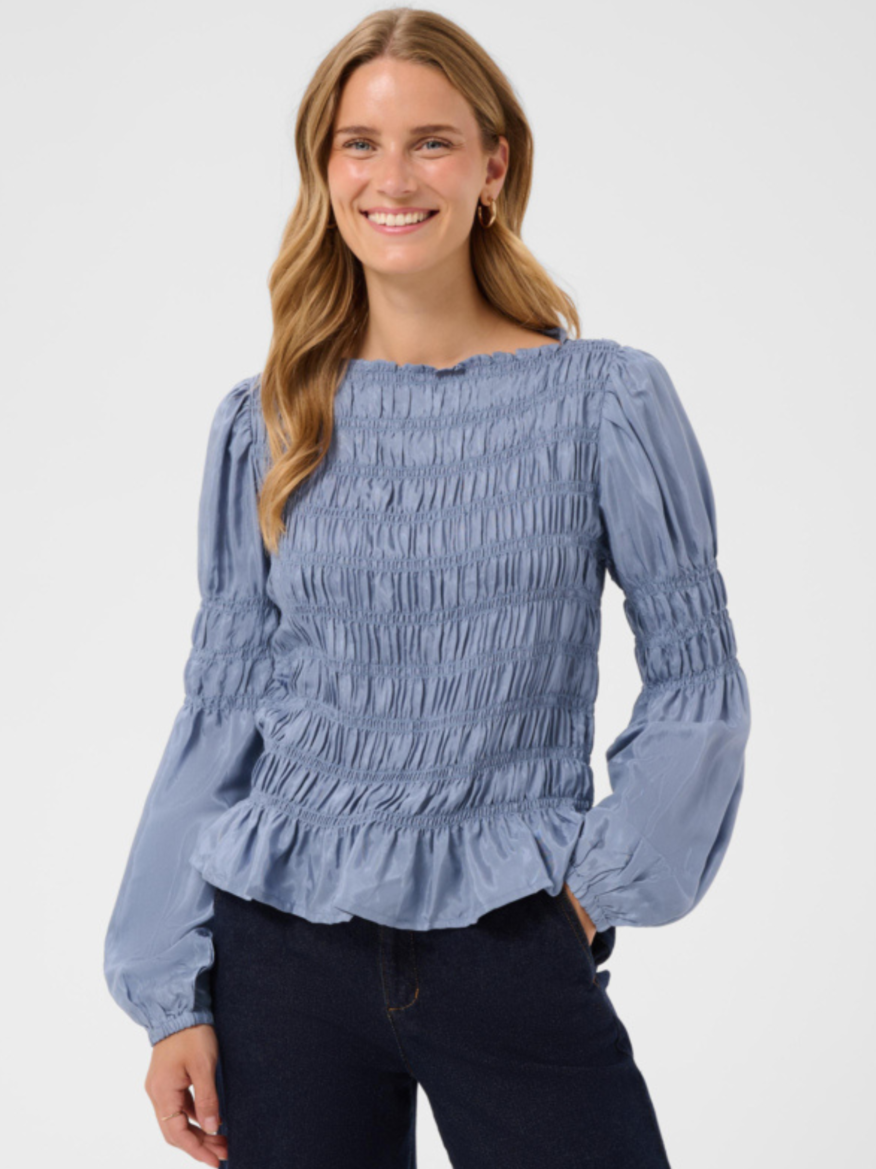 Cream Henva Blouse with shirred texture design and frill hem.