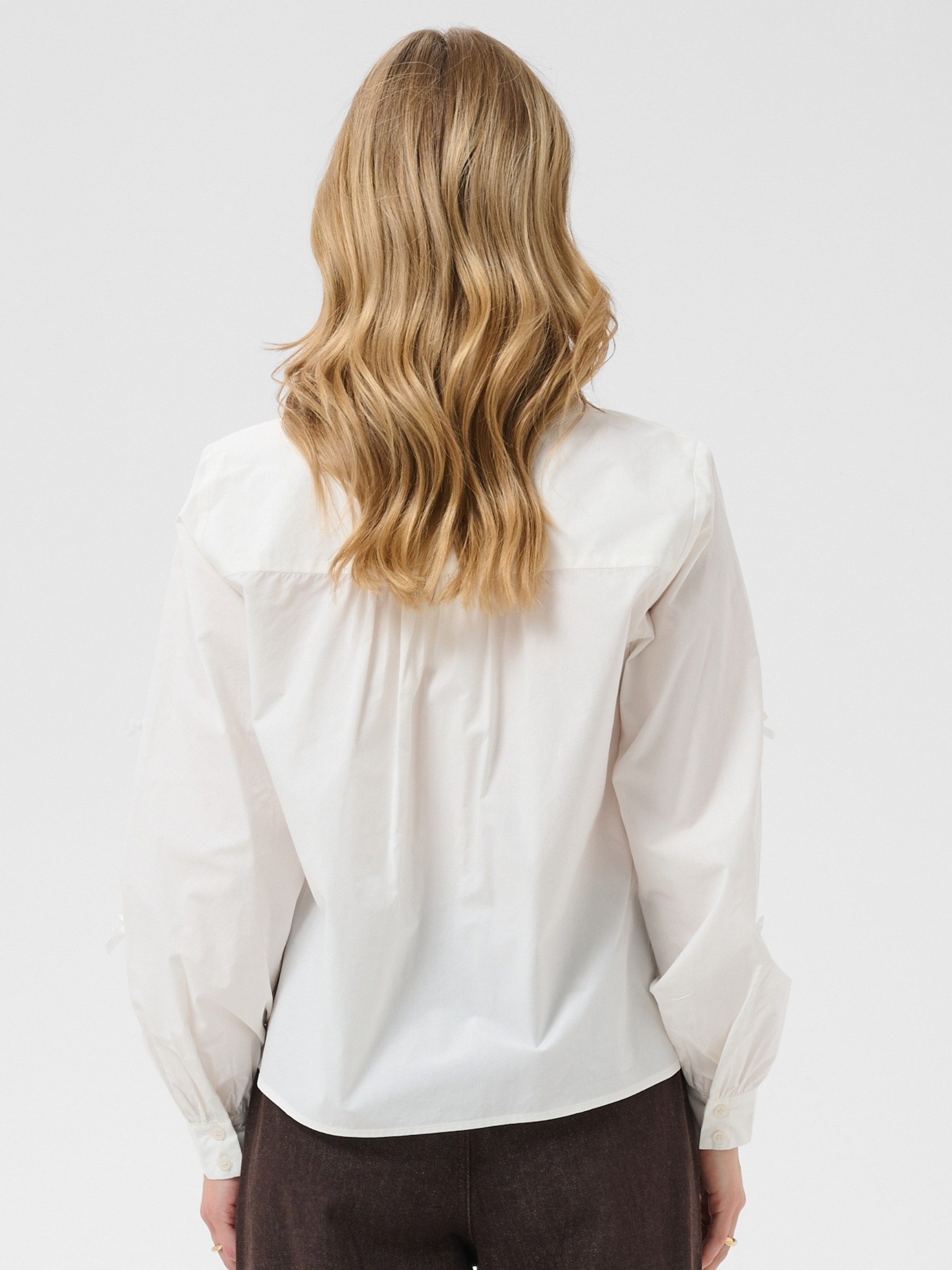 Cream Kit Shirt with classic collar, button front, bow details, long sleeves and regular fit