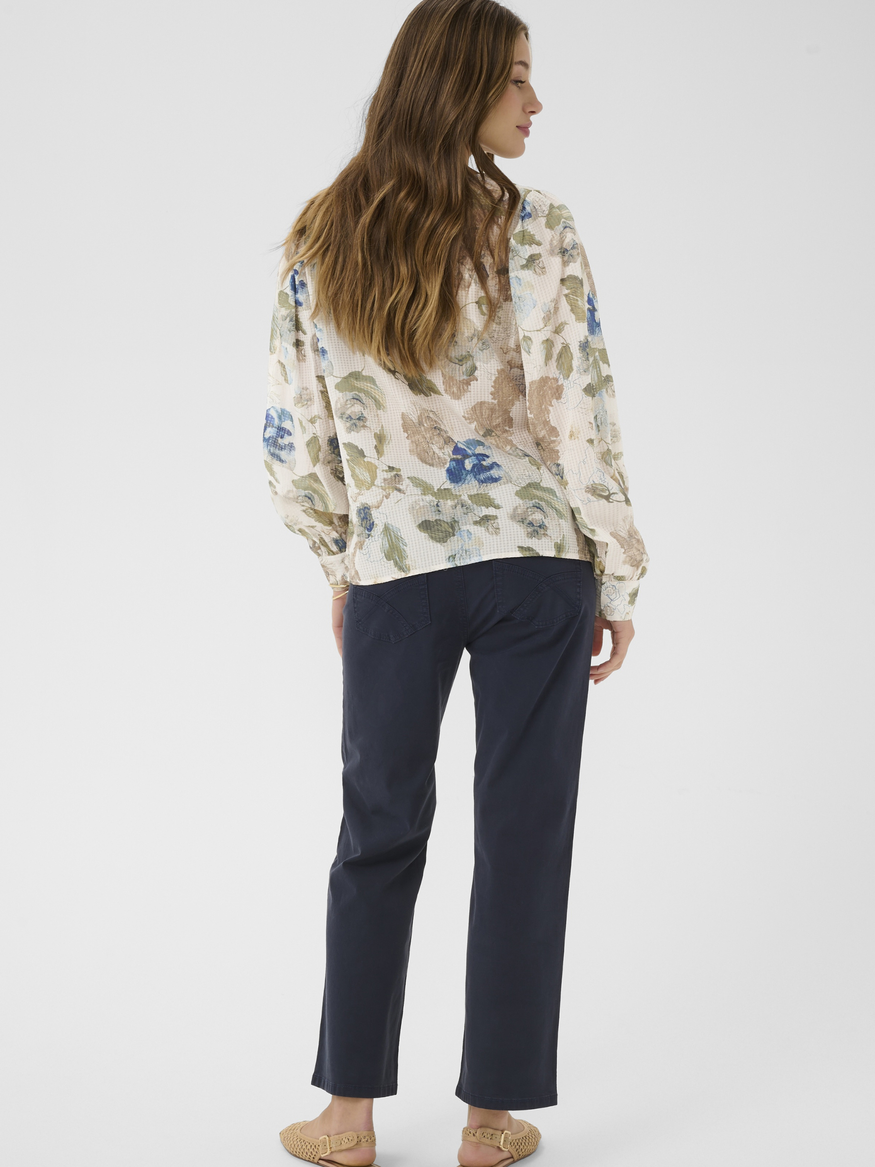 Cream Lucia floral V-neck blouse with long sleeves and button front in lightweight viscose cotton blend.