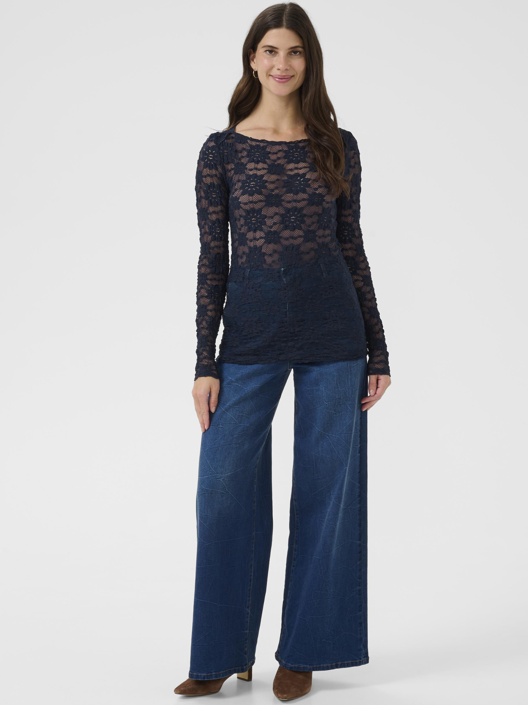Cream Maddie Blouse women’s slim-fit lace top with long sleeves and hip-length silhouette, styled with trousers.