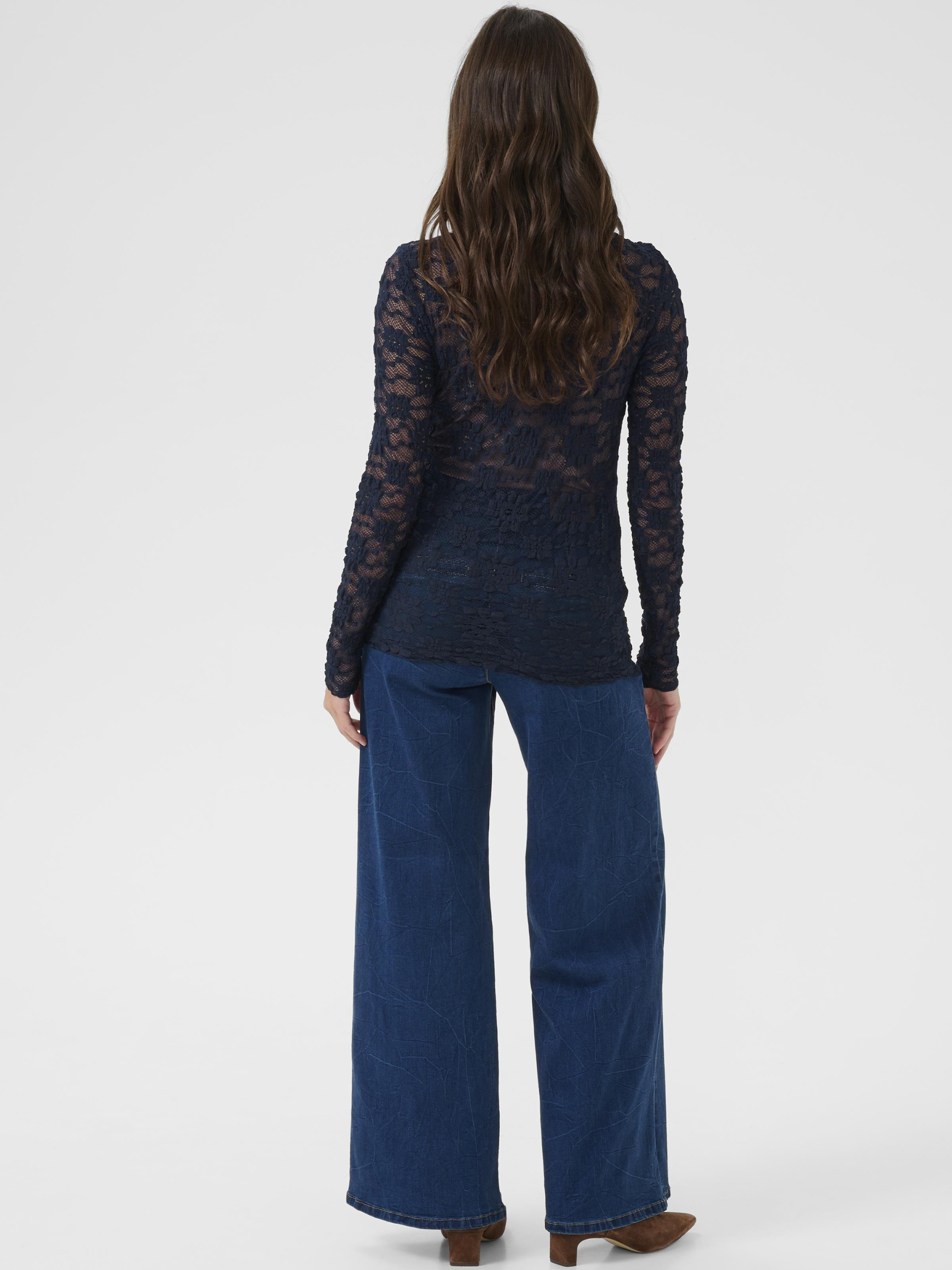 Cream Maddie Blouse women’s slim-fit lace top with long sleeves and hip-length silhouette, styled with trousers.