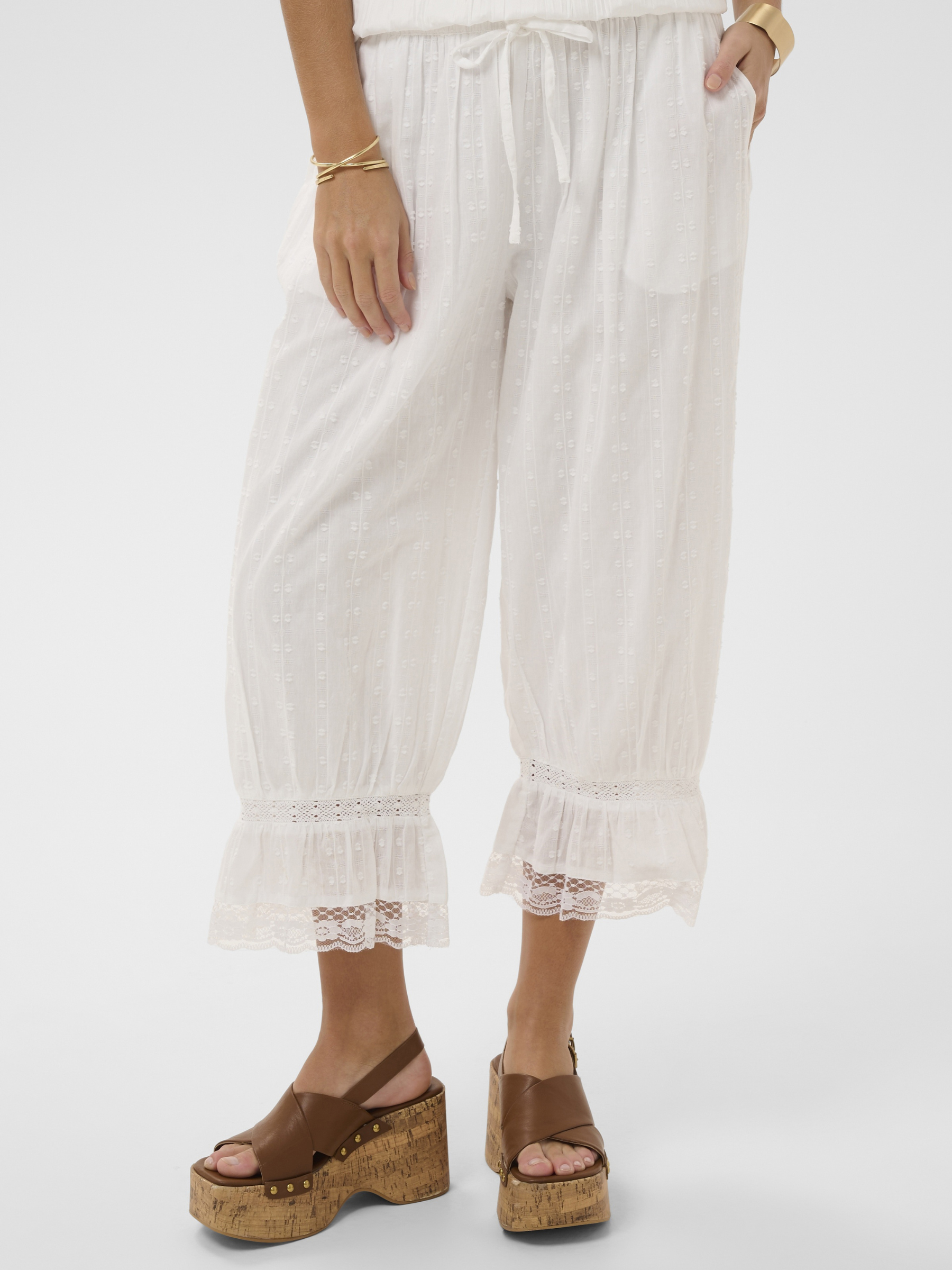 Cream Sereni Pant with textured cotton fabric, elasticated waist, lace trim and frill hem.