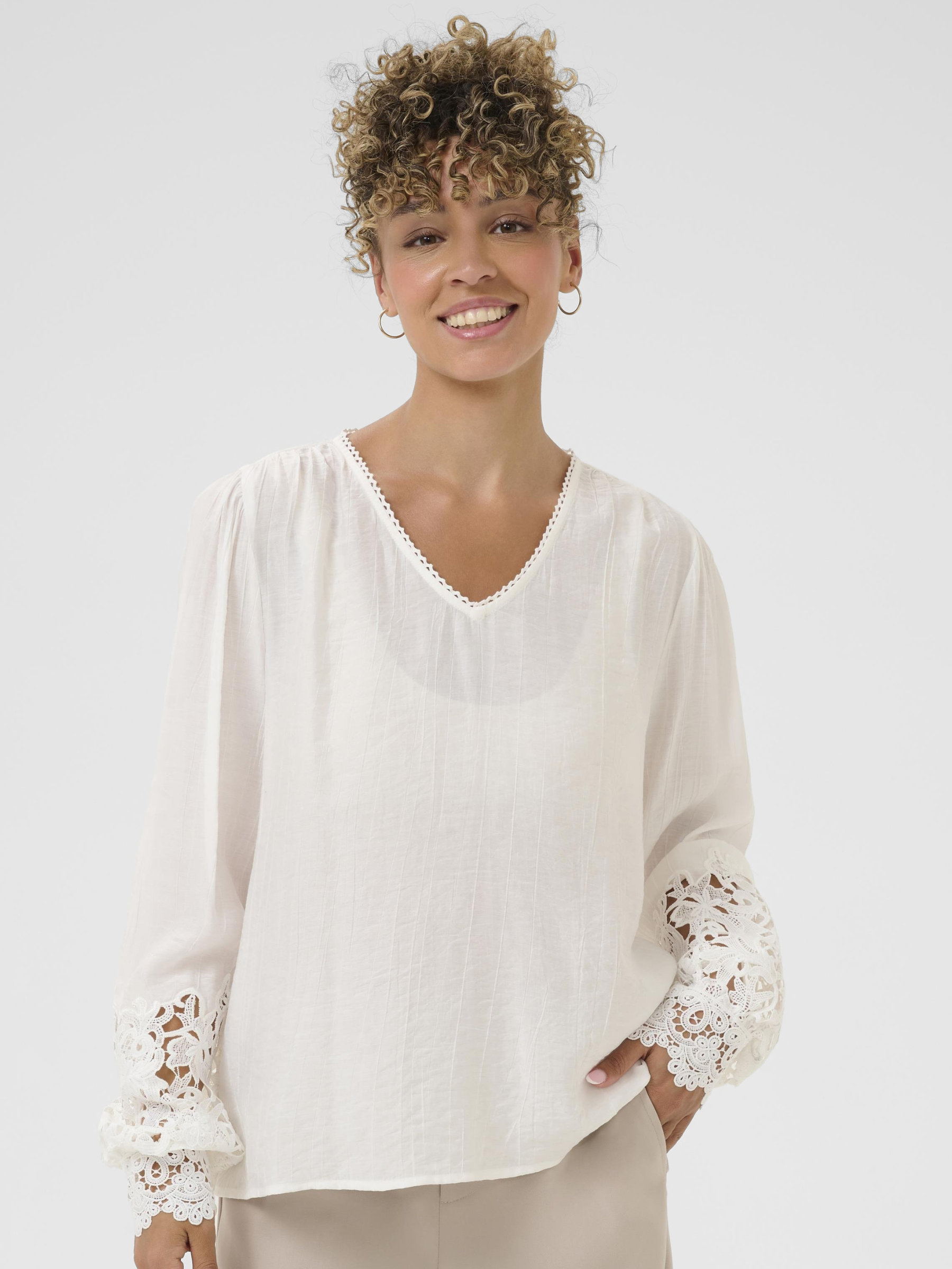 Cream Tina Blouse with V neckline, lace cuff detailing and long sleeves in a relaxed fit.