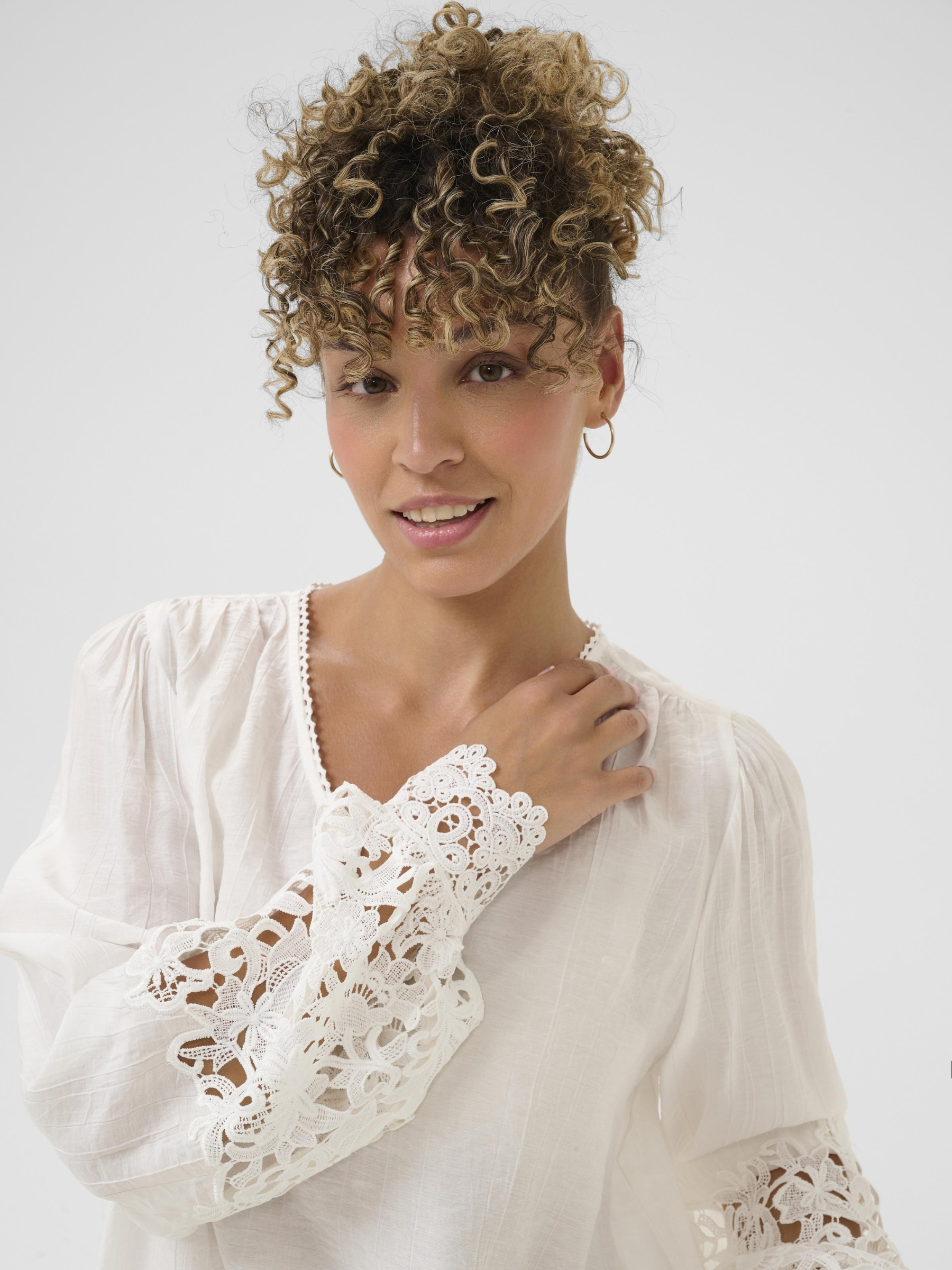 Cream Tina Blouse with V neckline, lace cuff detailing and long sleeves in a relaxed fit.