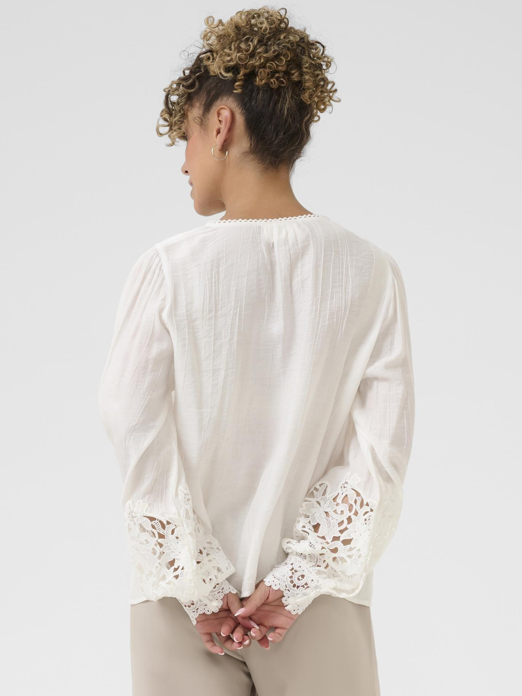 Cream Tina Blouse with V neckline, lace cuff detailing and long sleeves in a relaxed fit.