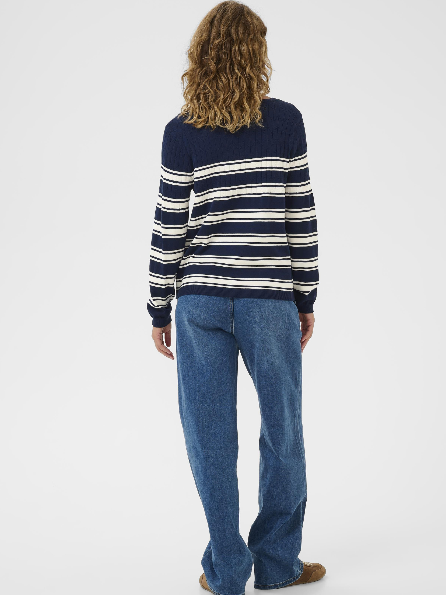 Cream Villea Pullover women’s regular fit long-sleeve knit with hip-length cut, styled casually with jeans.
