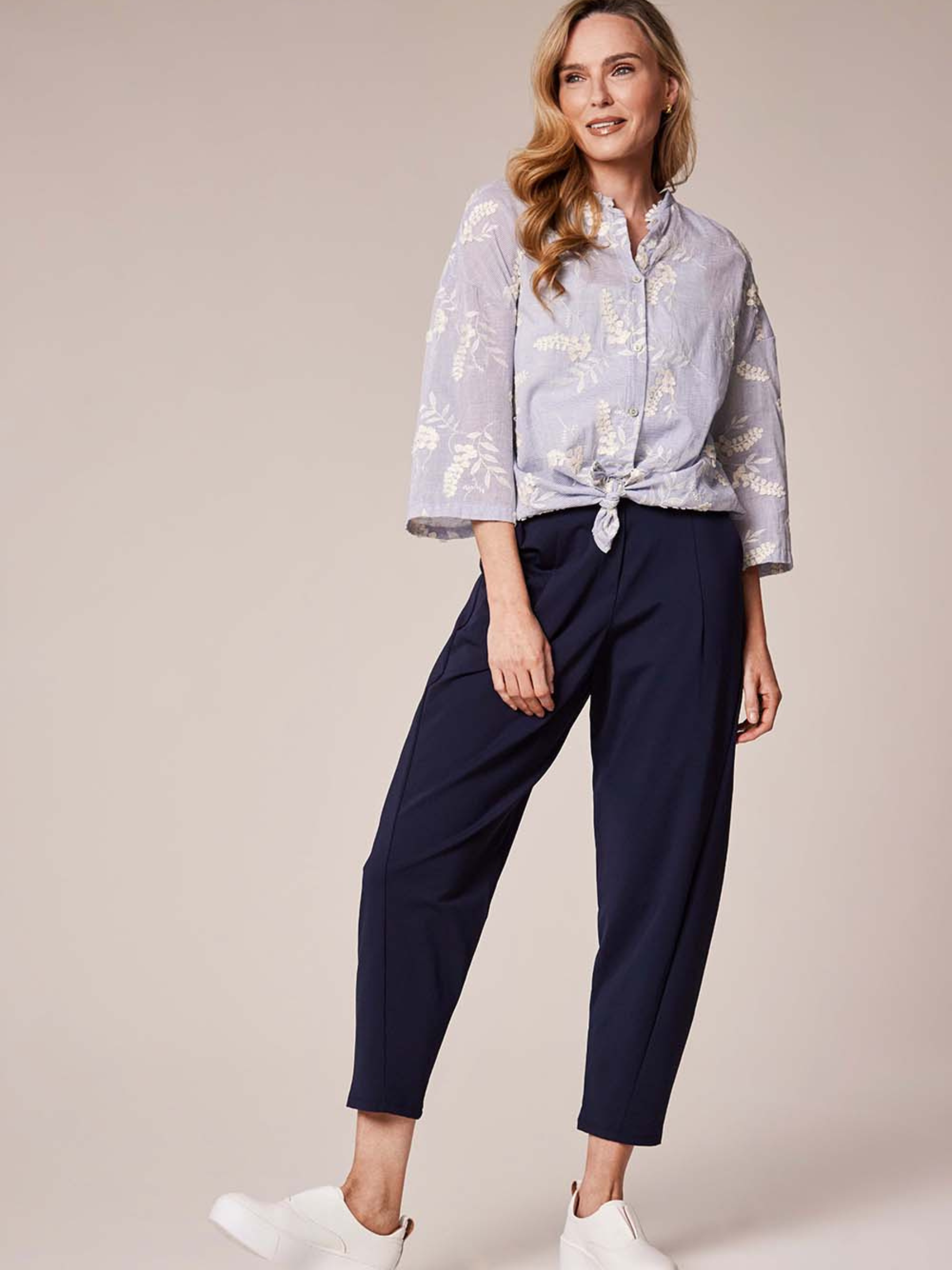 Deck By Decollage 2511 tapered tailored trousers with high-rise waistband and cropped ankle-length finish.