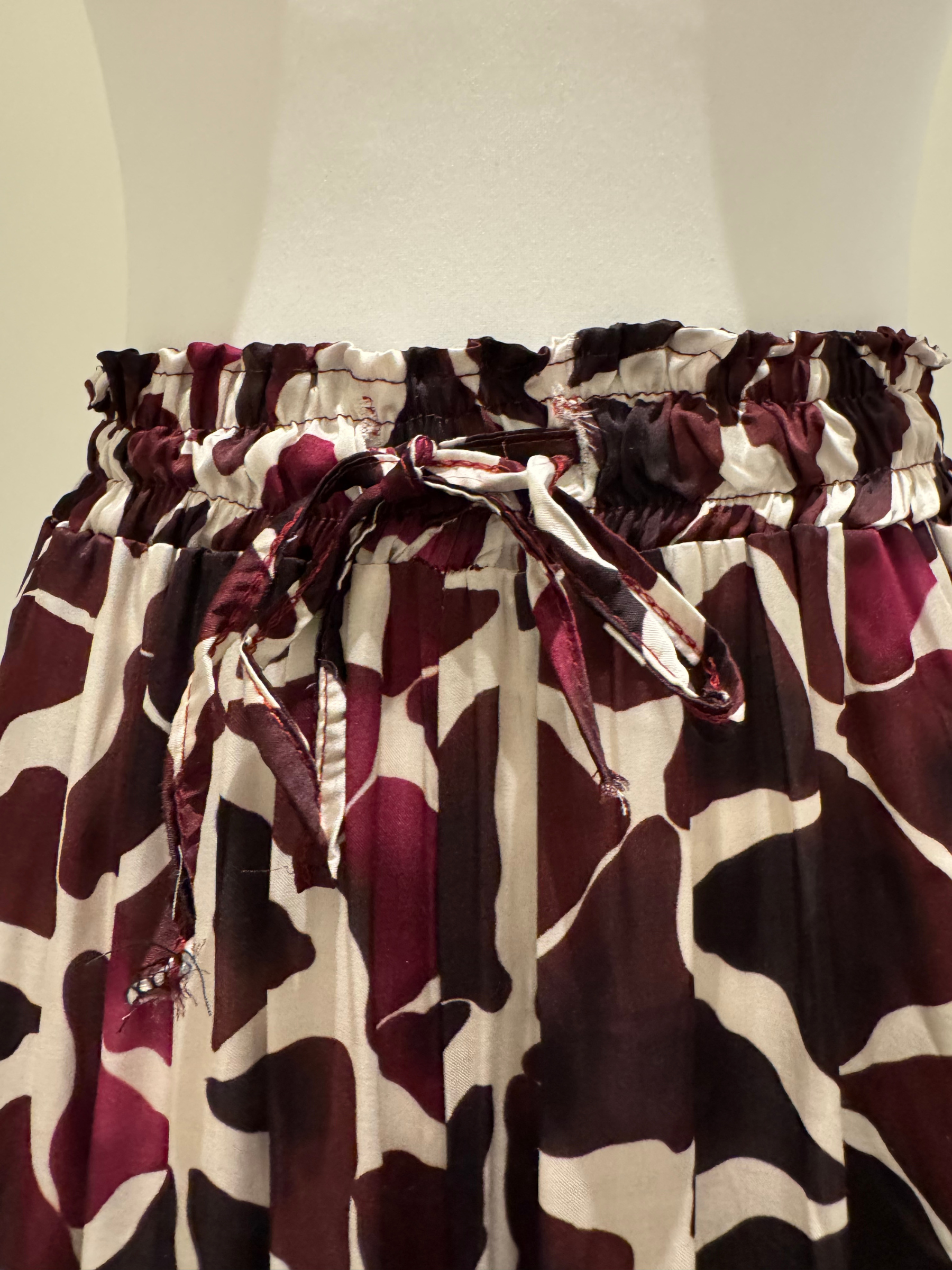 Deck by Decollage wide-leg trousers with an abstract berry and ivory print, featuring an elasticated waistband and fluid silhouette-designed for bold, stylish comfort.