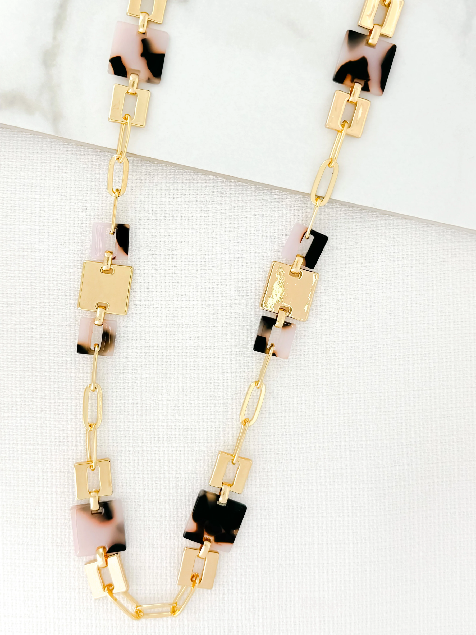 Envy 4301 Necklace featuring a gold-effect geometric link design with leopard-detail square embellishments, modern women’s statement necklace for day-to-night styling.