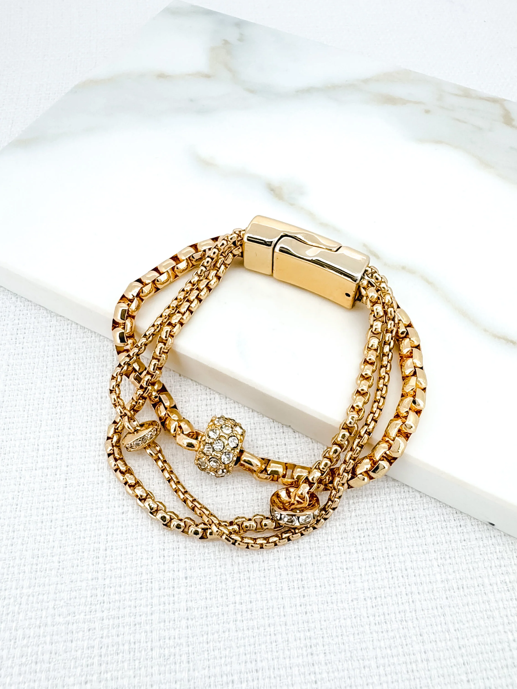 Envy 4395 Gold Bracelet featuring layered gold-effect chains with sparkling crystal embellishments and magnetic clasp, a chic women’s jewellery piece perfect for evening wear or everyday elegance.