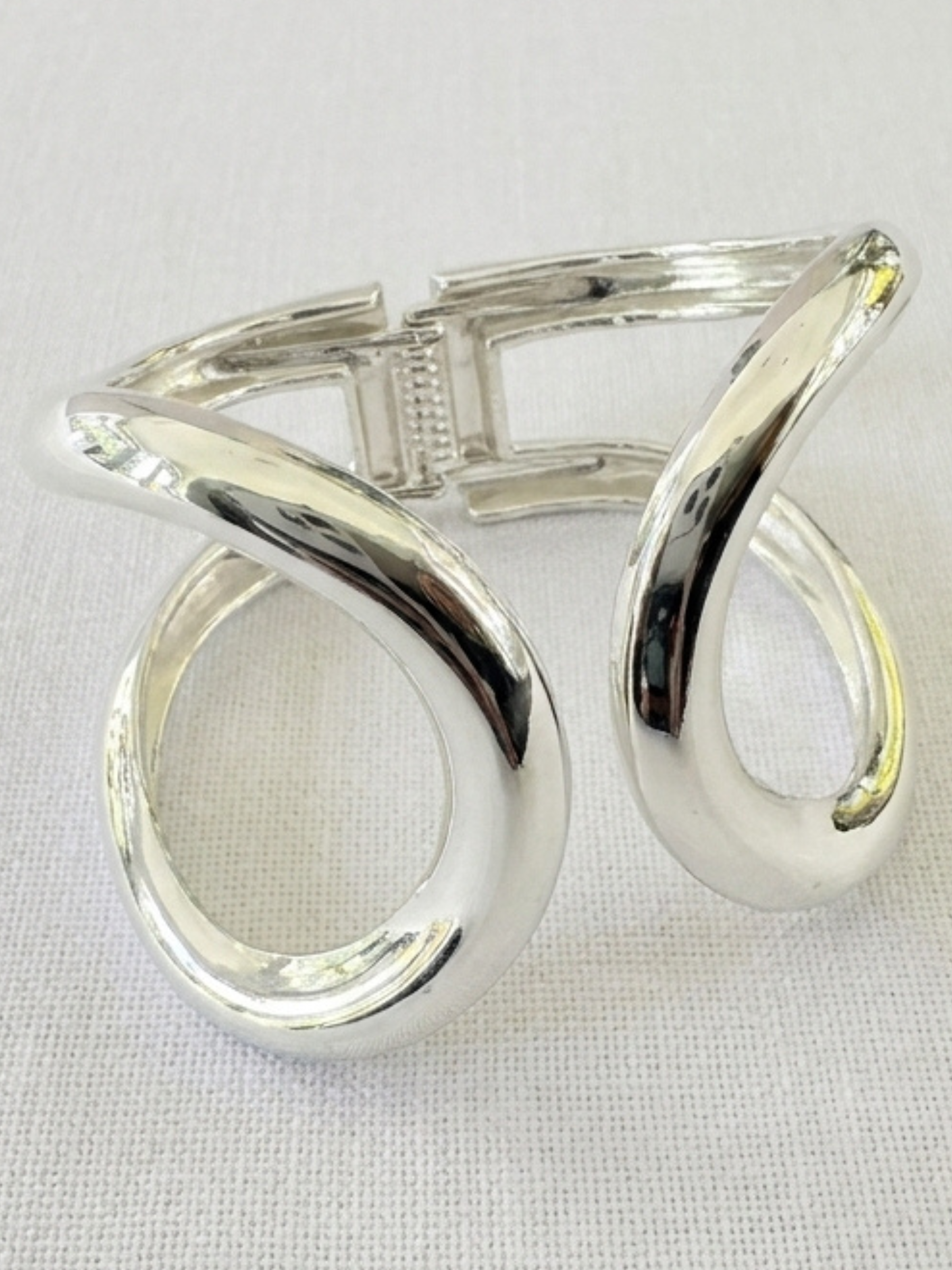 Envy 4707 Double Looped Hinged Bangle Bracelet with sculptural double-loop design and smooth polished finish.