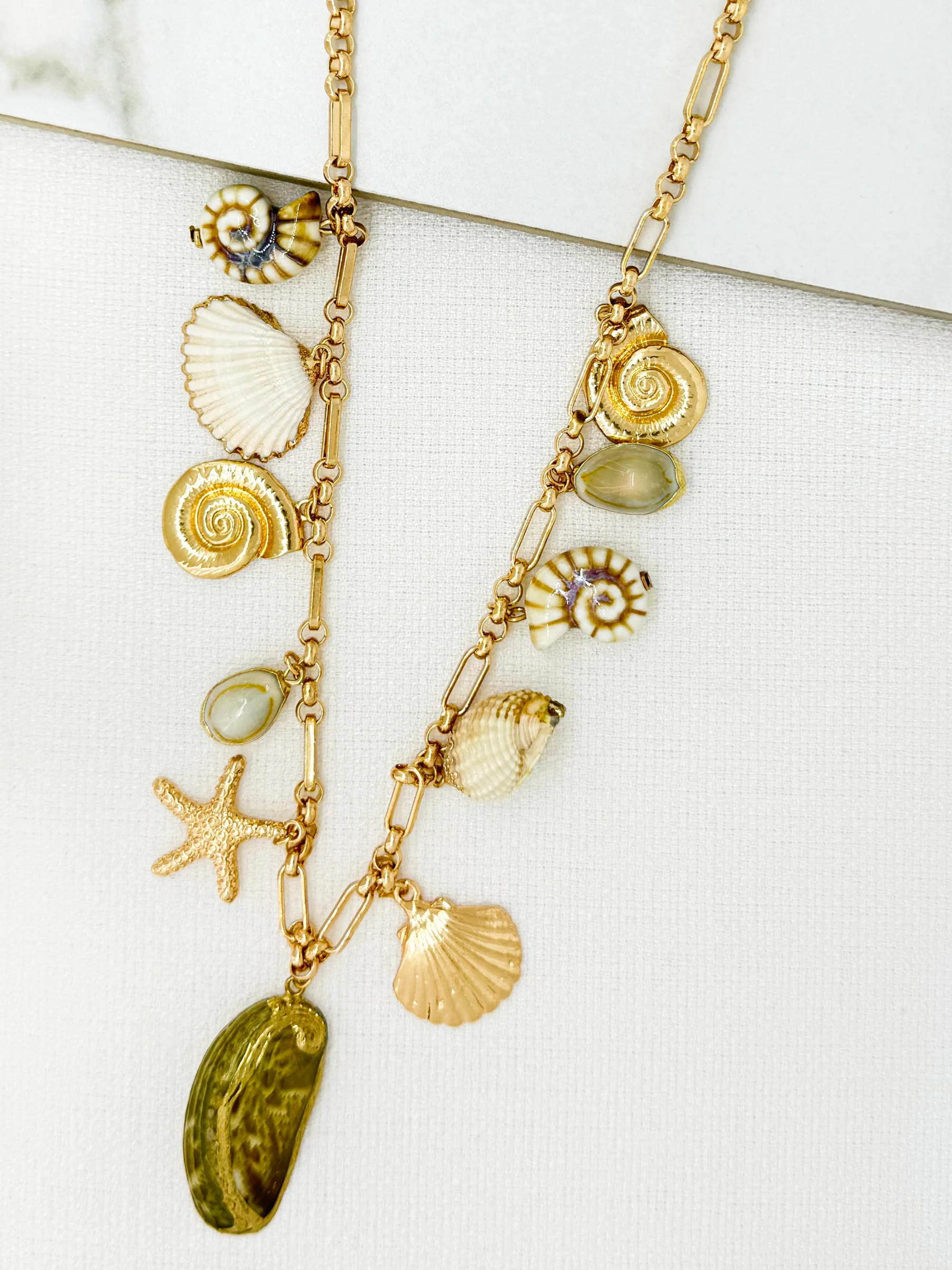 Envy 4809 Shell Charm Long Necklace with mixed shell charms and gold-tone chain.