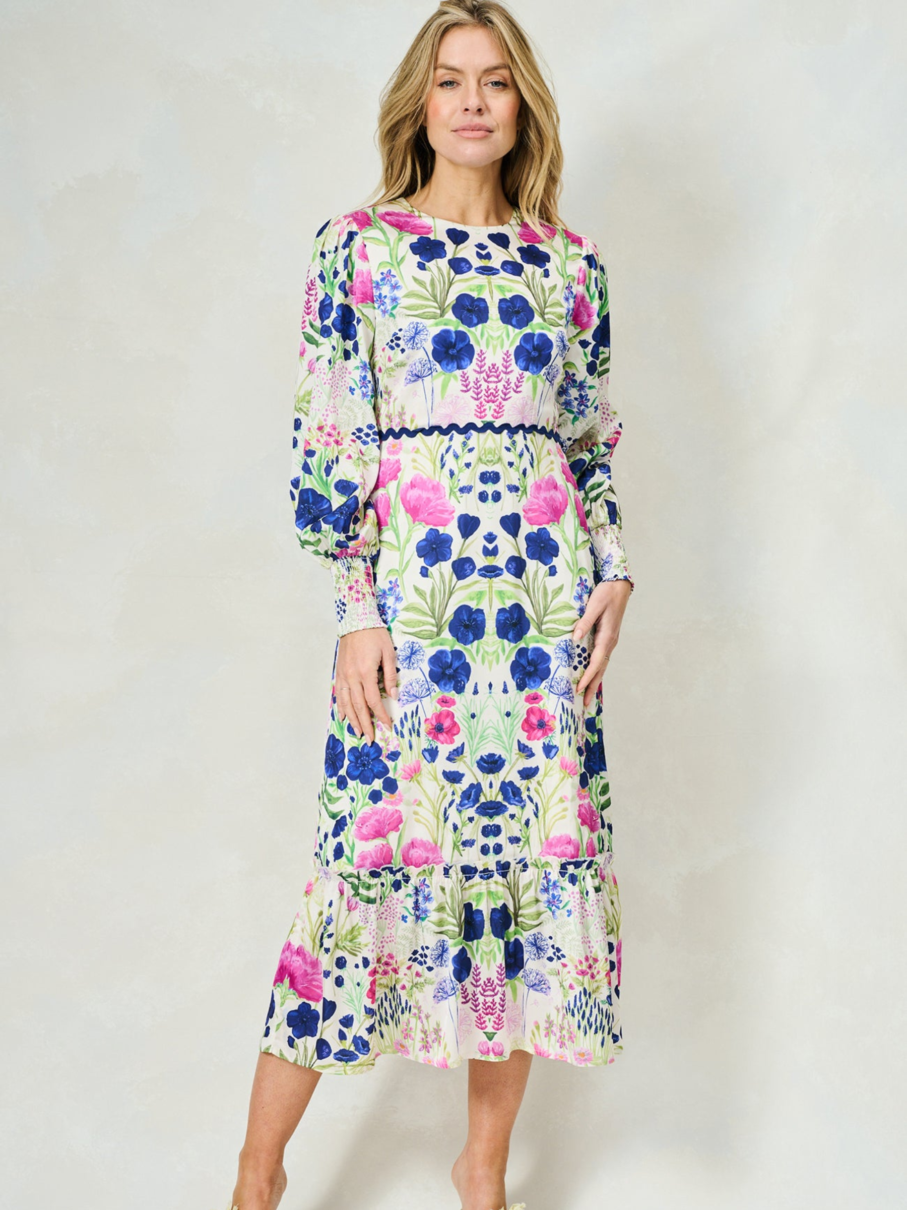 Hope & Ivy Caroline White Floral Maxi Dress – sustainable women’s satin floral print dress with blouson sleeves, frilled hem and tie-back detail. Ideal for weddings, garden parties and summer occasions.