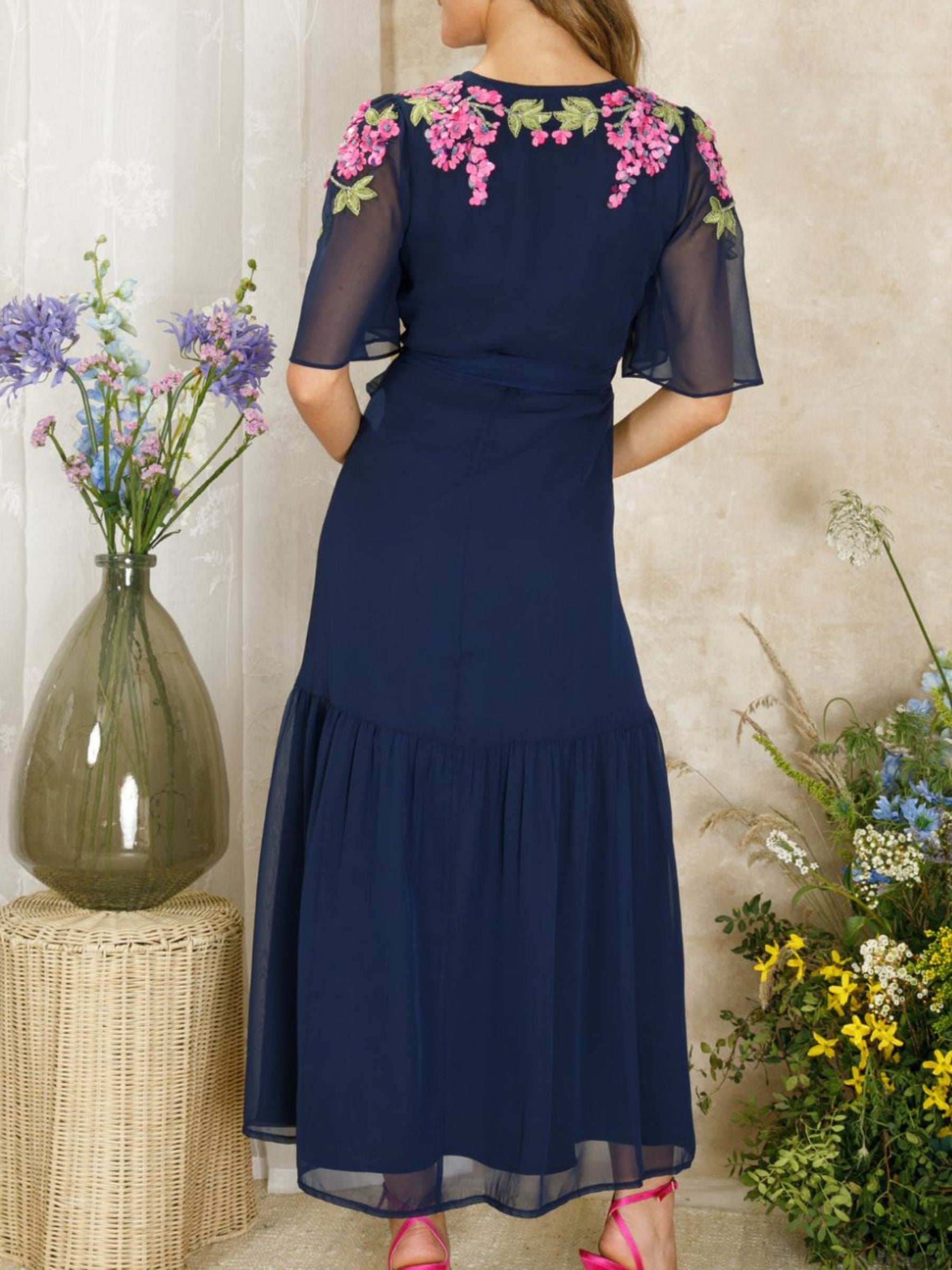 Hope & Ivy Grace navy embellished wrap dress with flutter sleeves, tie waist and pink/purple wisteria detail; maxi length approx. 143 cm.