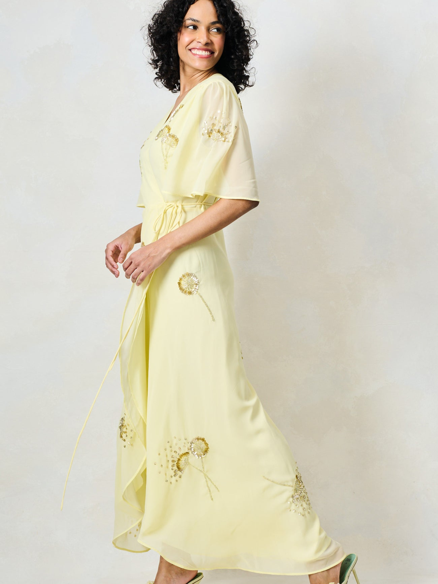 Hope & Ivy Joy Yellow Dress with wrap silhouette, flutter sleeves, embellished detailing and flowing maxi skirt.