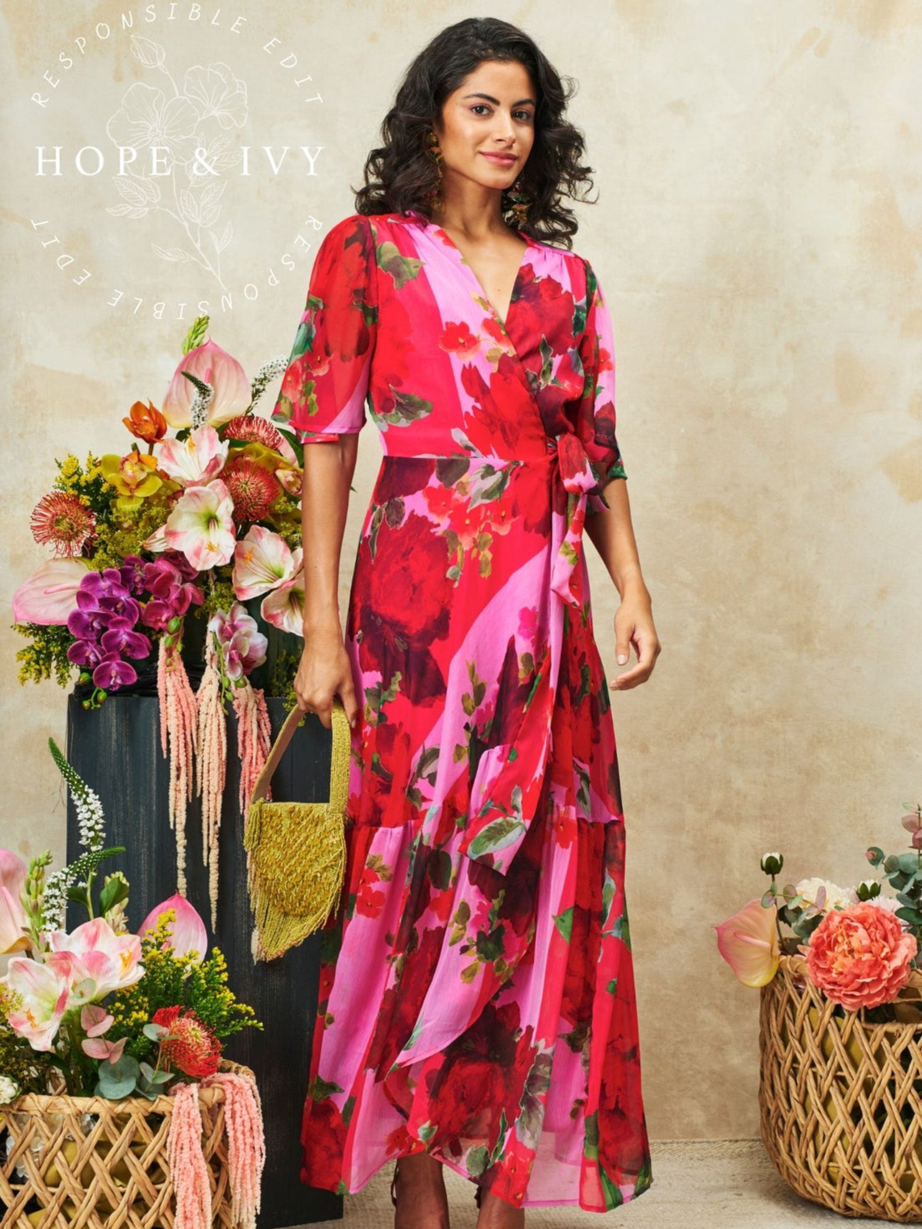 Hope & Ivy Rosanna Pink & Red Dress with wrap-style silhouette, V-neckline, flutter sleeves, tie waist and flowing maxi skirt with front split.