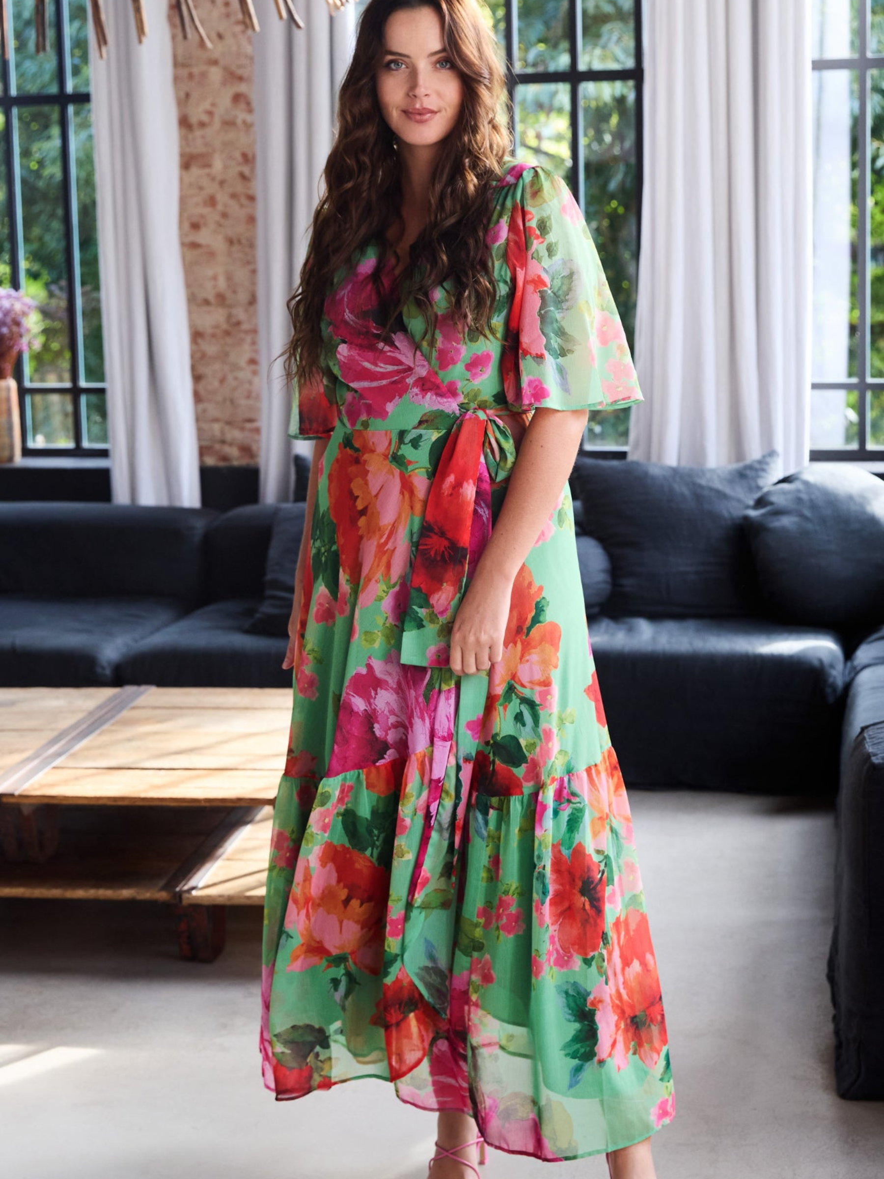 Hope & Ivy Samantha Green Floral Dress with wrap silhouette, flutter sleeves, tie waist and flowing maxi skirt.