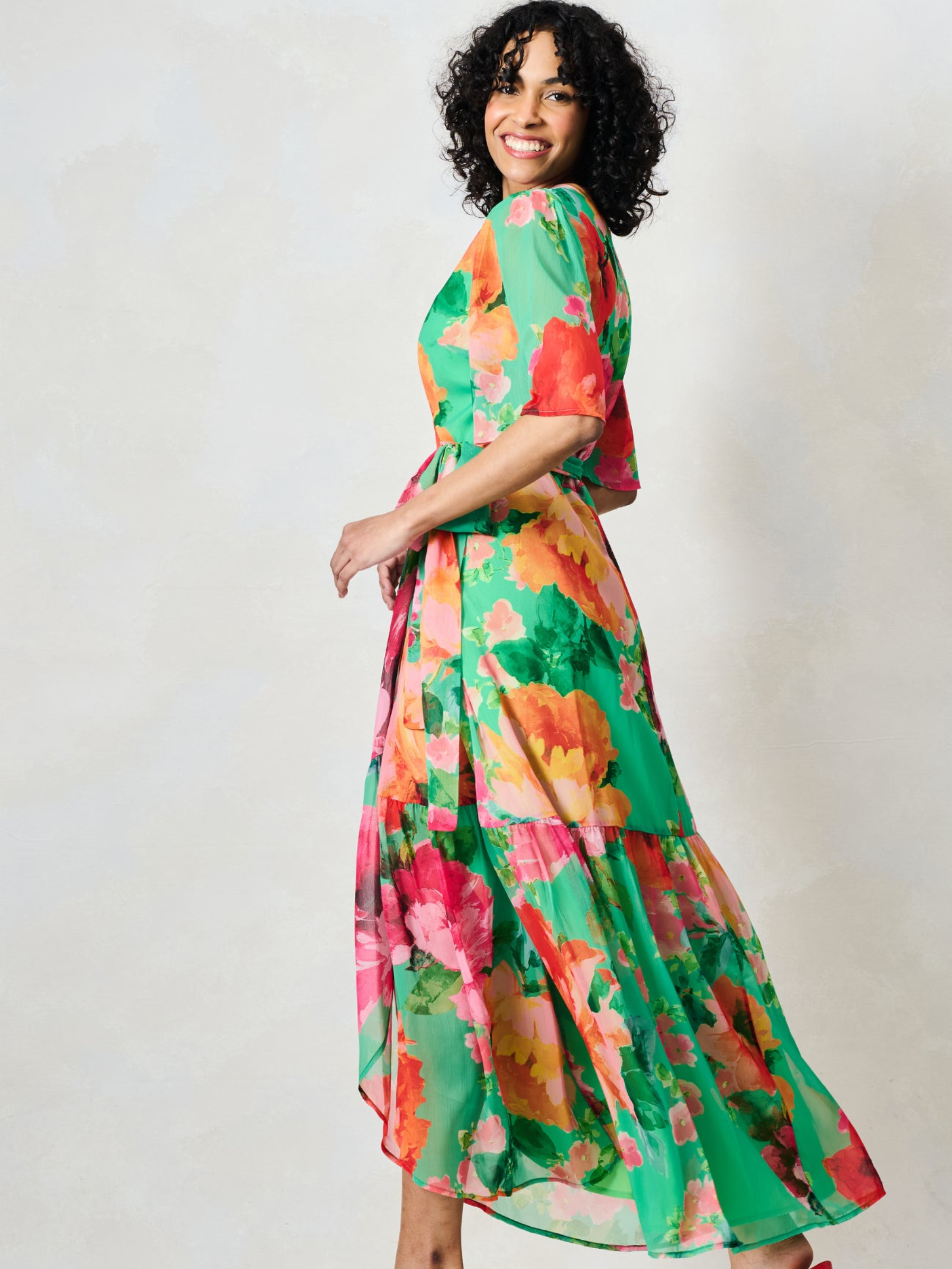 Hope & Ivy Samantha Green Floral Dress with wrap silhouette, flutter sleeves, tie waist and flowing maxi skirt.
