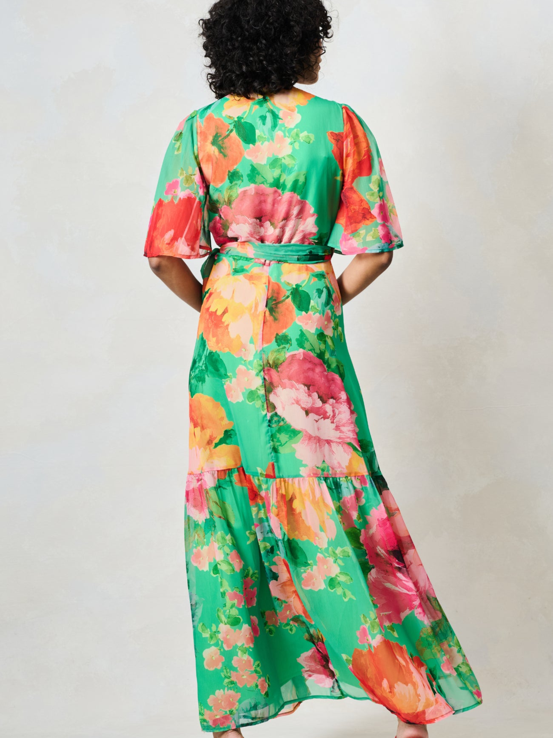 Hope & Ivy Samantha Green Floral Dress with wrap silhouette, flutter sleeves, tie waist and flowing maxi skirt.