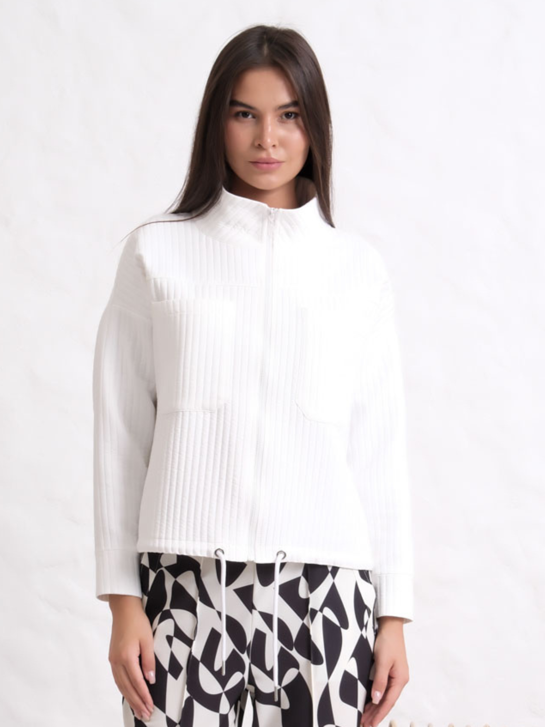 Inco 1207 zip up jacket with textured fabric, high neckline and drawstring hem.