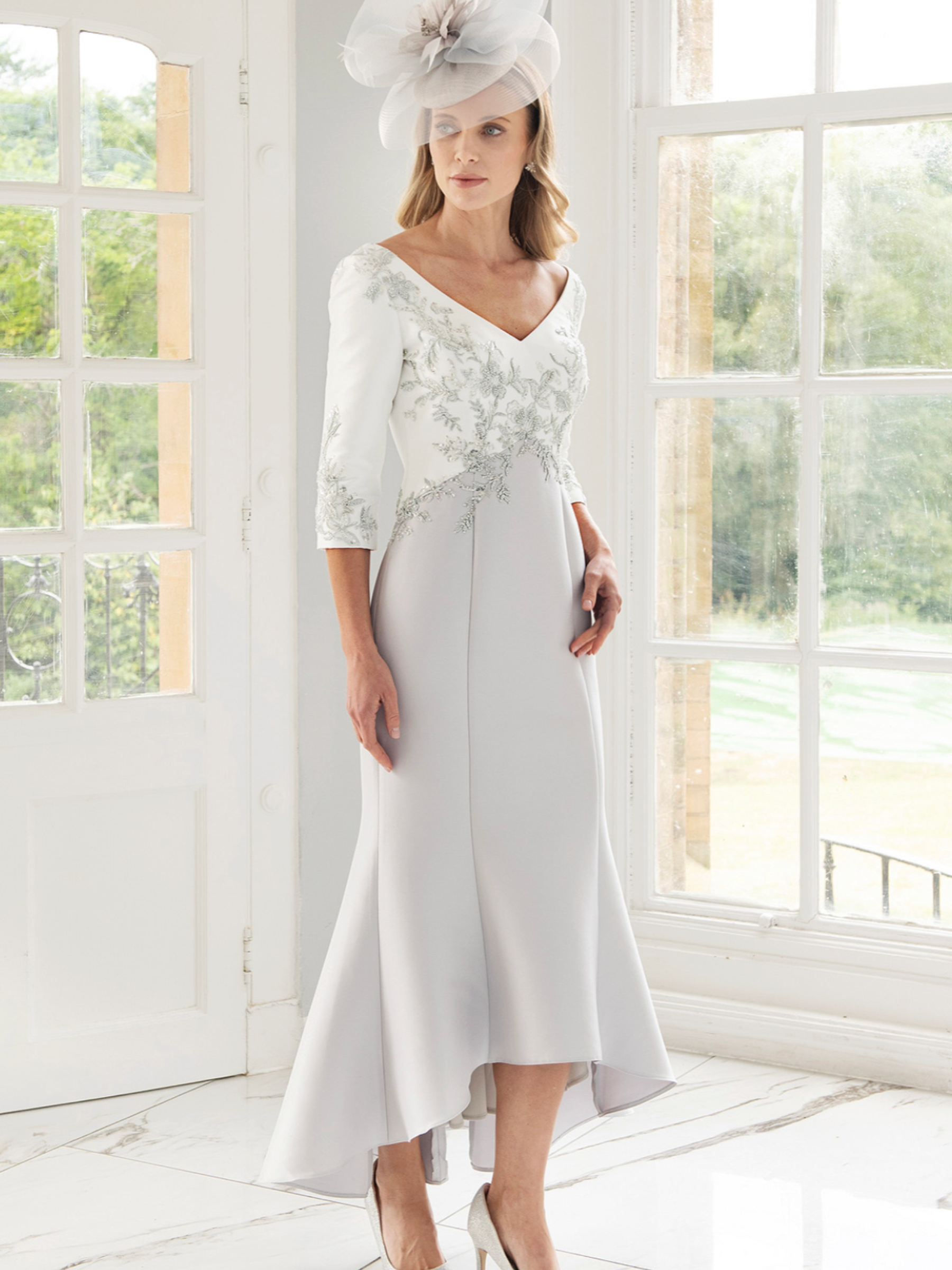 Irresistible IR8812TJ Ivory/Silver Dress with embroidered ivory bodice, V-neckline, three-quarter sleeves and a flowing high-low silver skirt — an elegant occasion dress perfect for weddings and formal events.