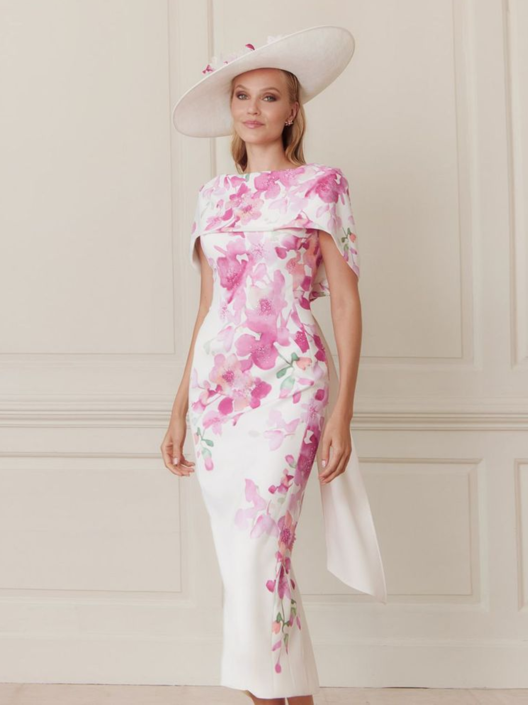 John Charles 66698 Petal Dress with floral crepe fabric, cape-style shoulder overlay and a sleek fitted silhouette — a romantic occasion dress ideal for weddings and elegant events.