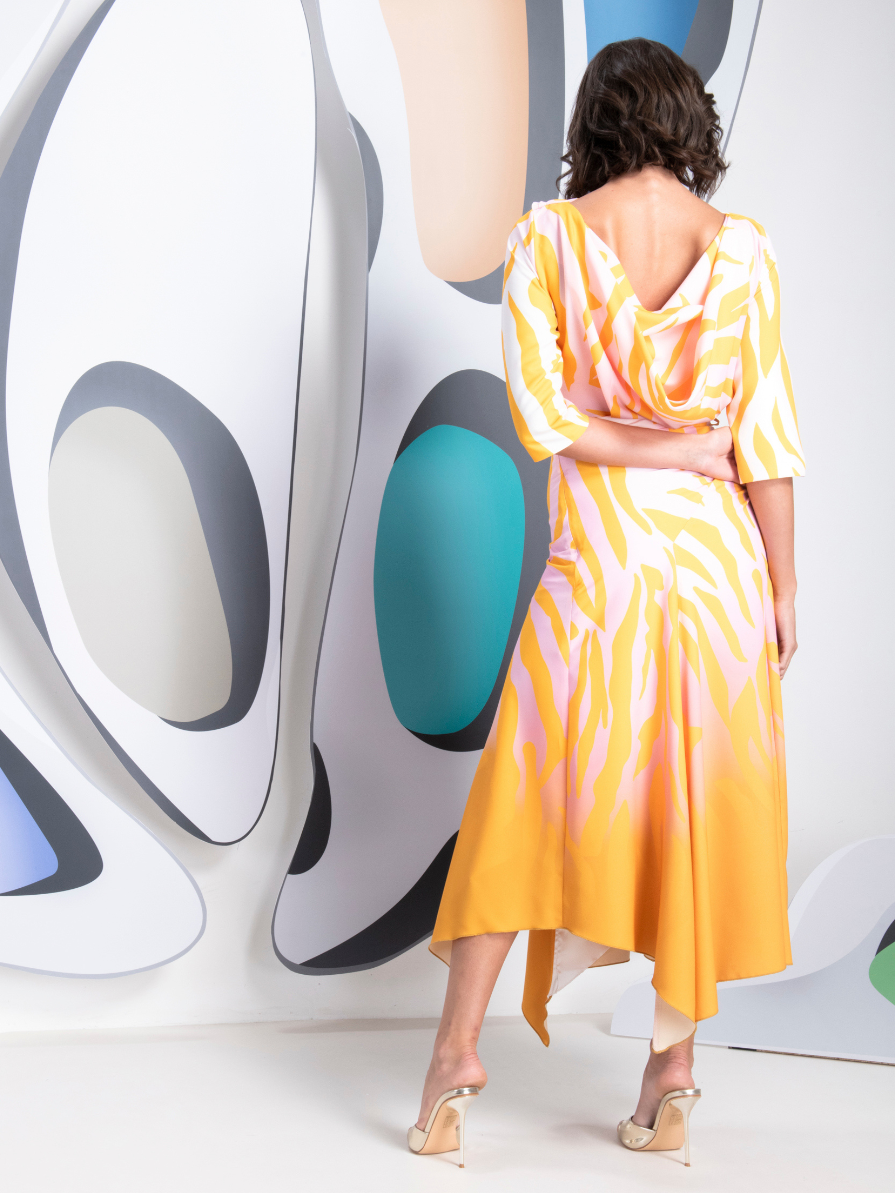 Kevan Jon Dotty Pink/Yellow Sleeve Drape Dress in zebra ombré fabric with high neckline, ruched tie waist and asymmetric draped skirt with side split.