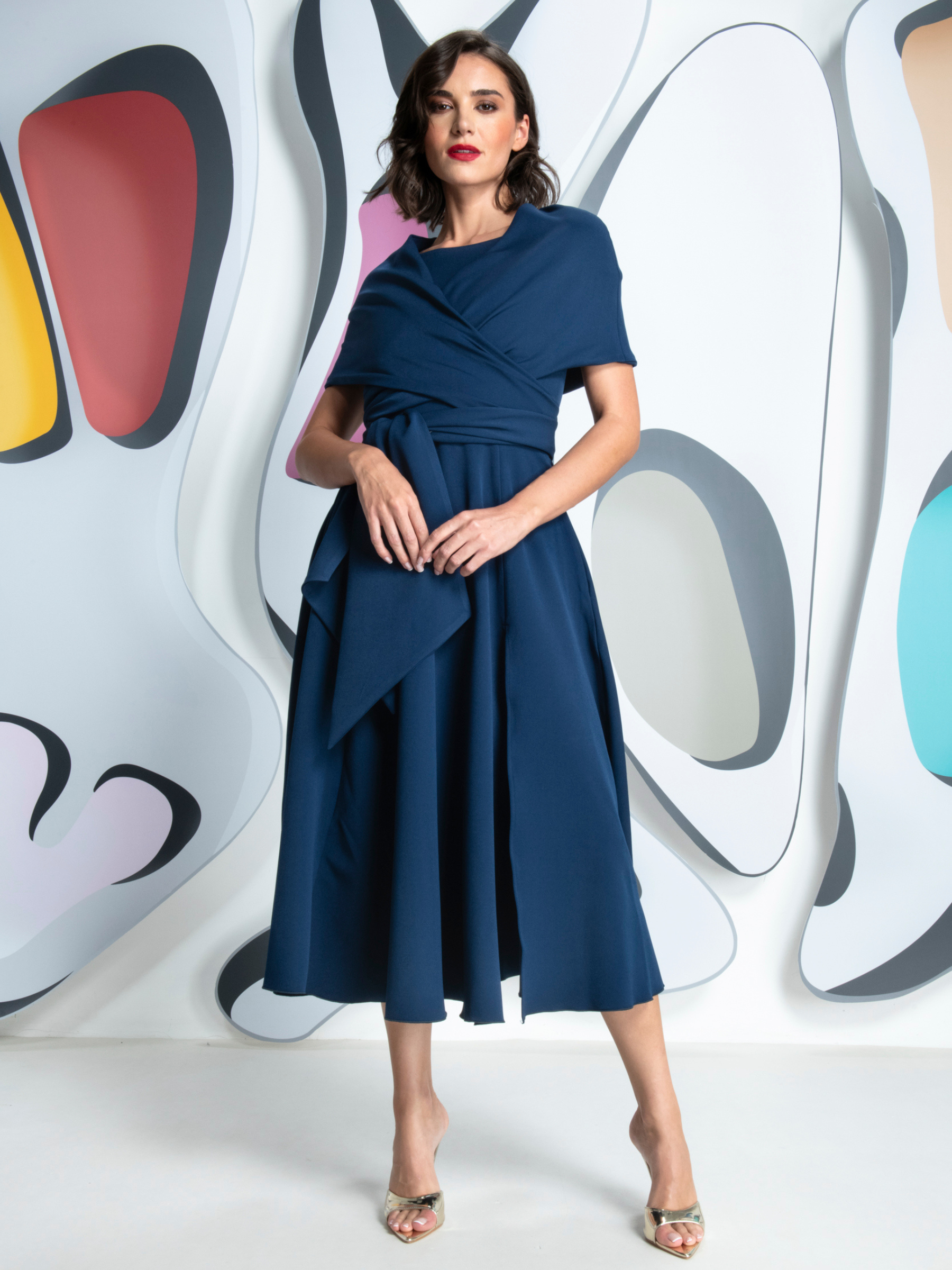 Kevan Jon Sydney Navy Flare Dress & Cape in Delauney Scuba with a fitted bodice, flared midi skirt and matching draped shoulder cape.