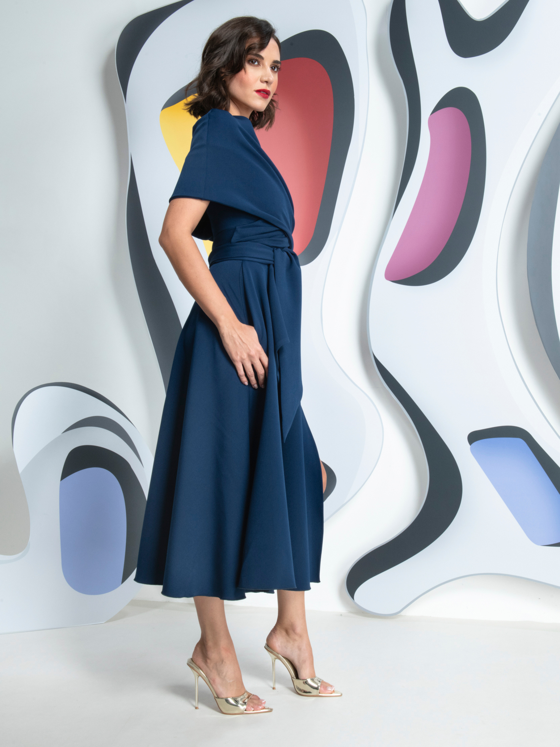 Kevan Jon Sydney Navy Flare Dress & Cape in Delauney Scuba with a fitted bodice, flared midi skirt and matching draped shoulder cape.