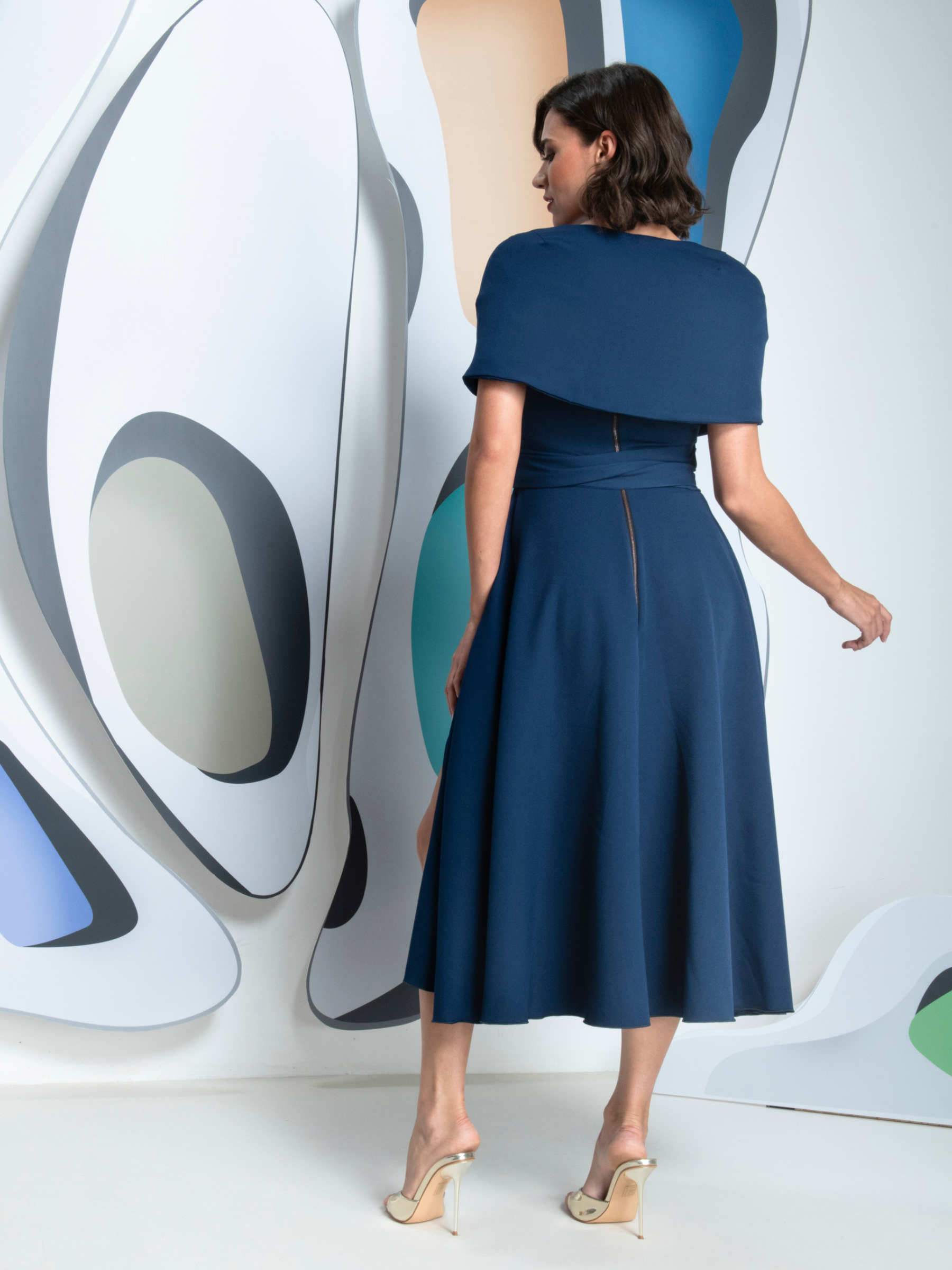 Kevan Jon Sydney Navy Flare Dress & Cape in Delauney Scuba with a fitted bodice, flared midi skirt and matching draped shoulder cape.