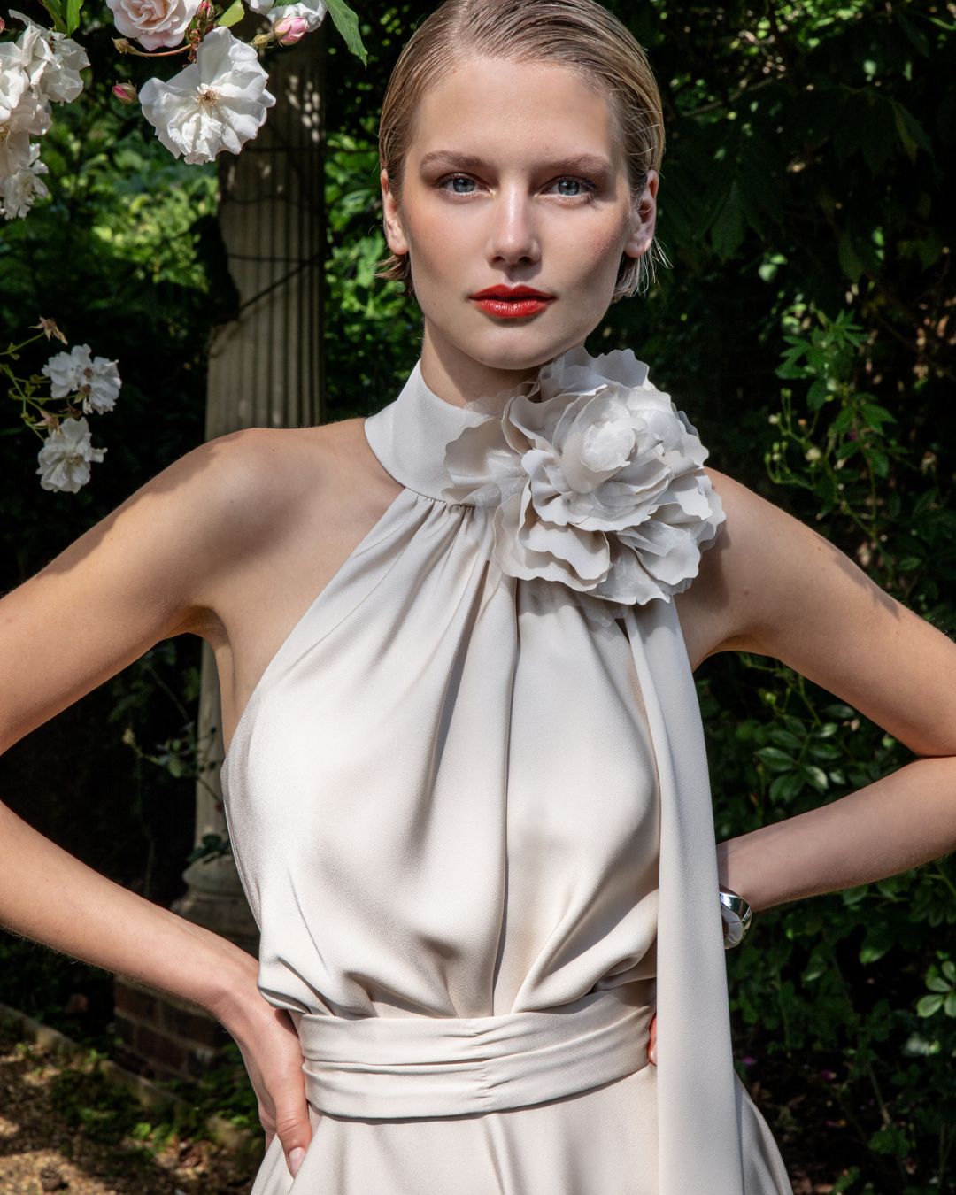 Maisonel ME3004 Oyster Dress – women’s halter neck satin occasion dress in elegant oyster tone with floral applique and asymmetric hem, perfect for weddings and formal events.