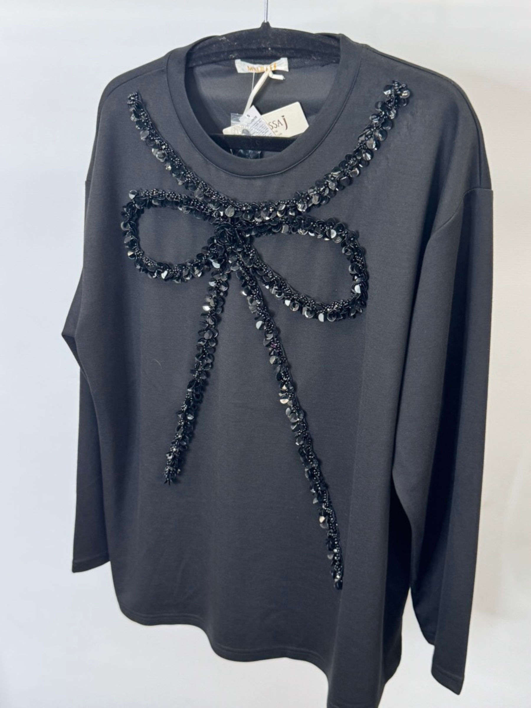 Malissa J WF2503 black sequin bow top—women’s embellished long-sleeve jersey top with statement bow detail.