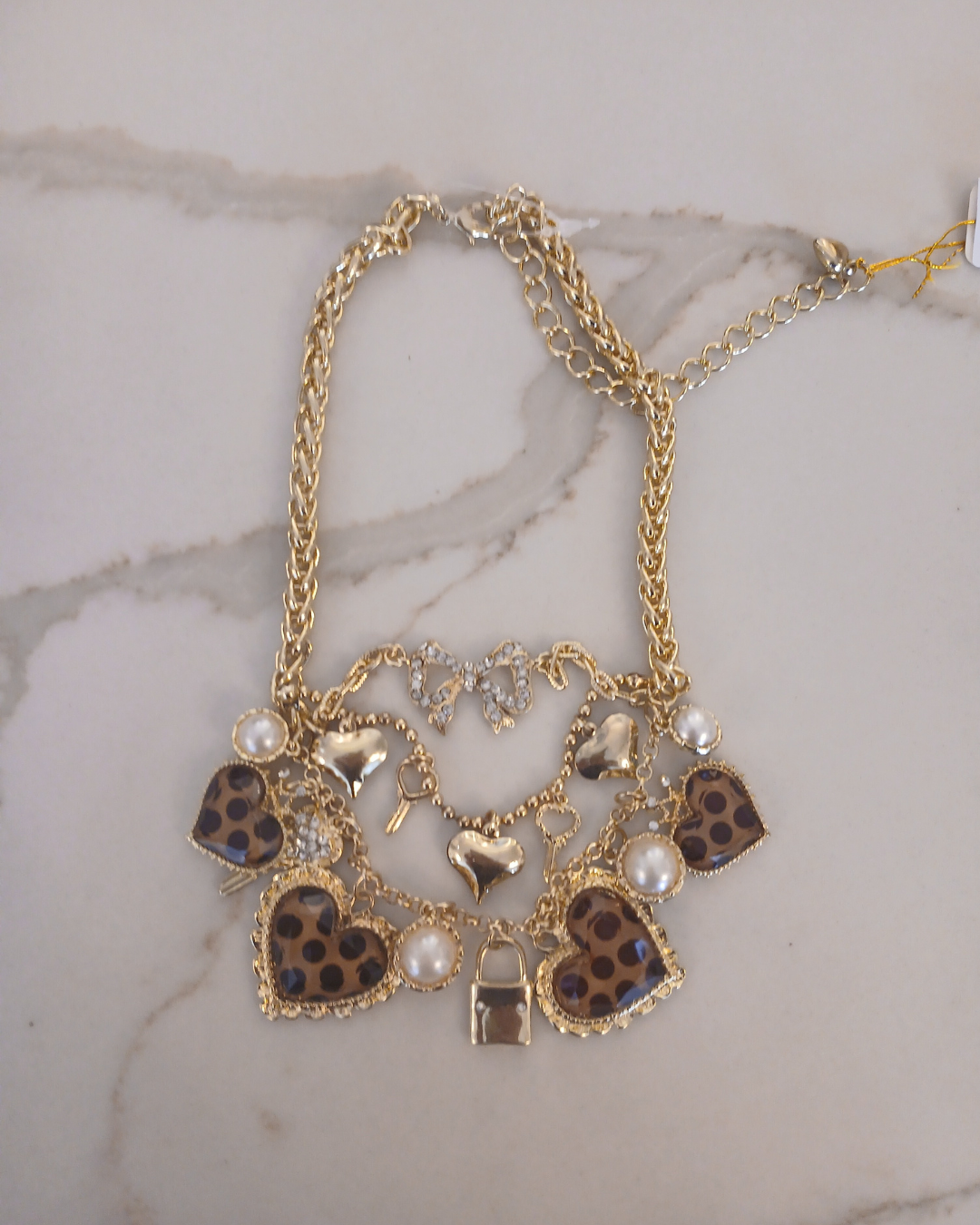 Layered gold necklace with heart and key shaped charms