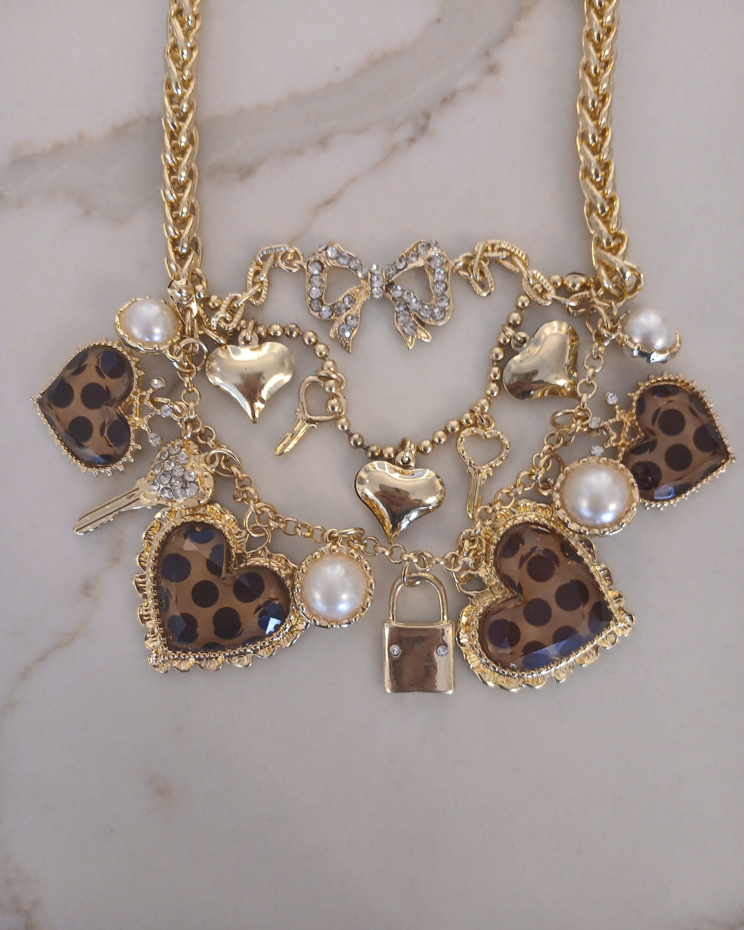 Layered gold necklace with heart and key shaped charms