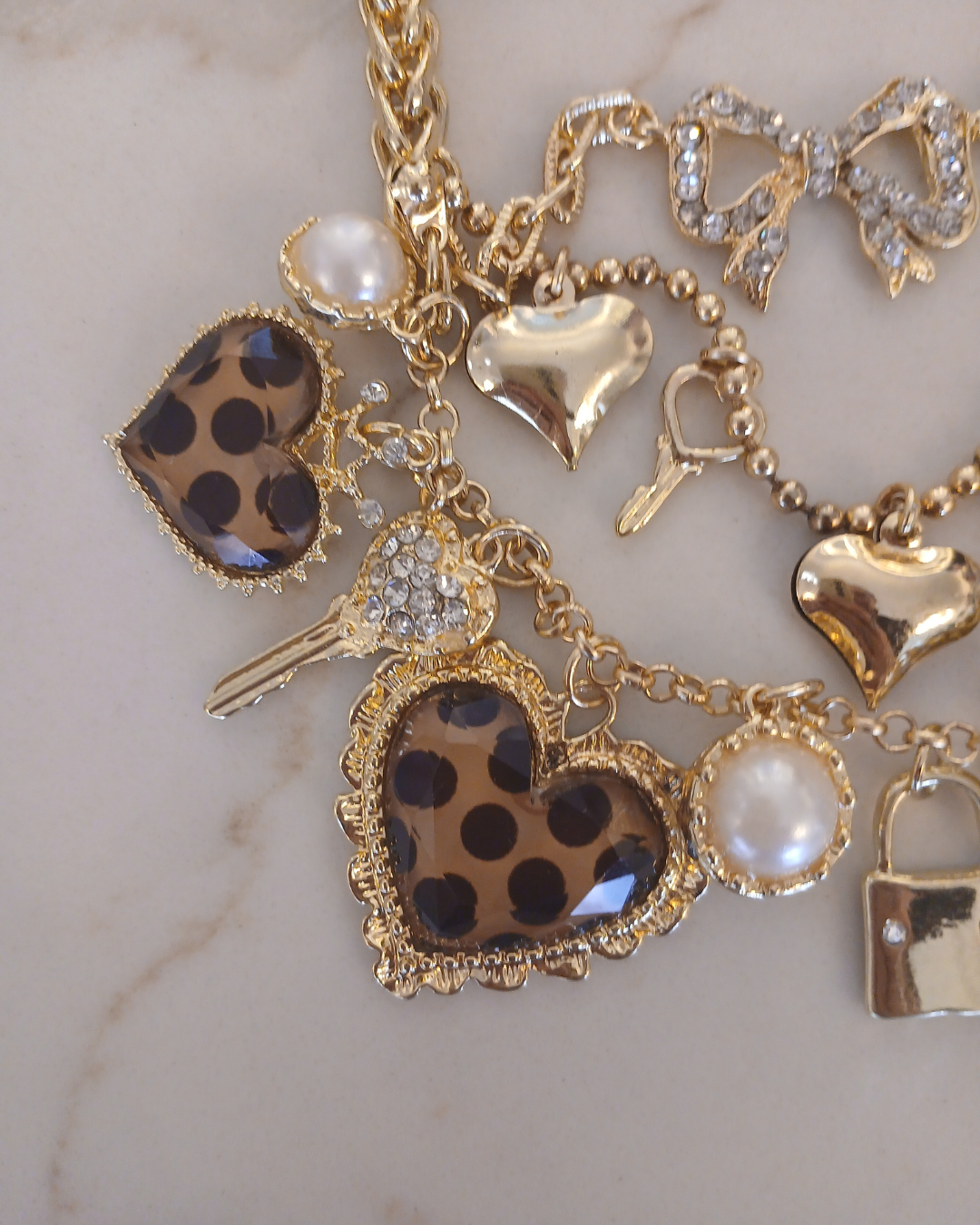 Layered gold necklace with heart and key shaped charms