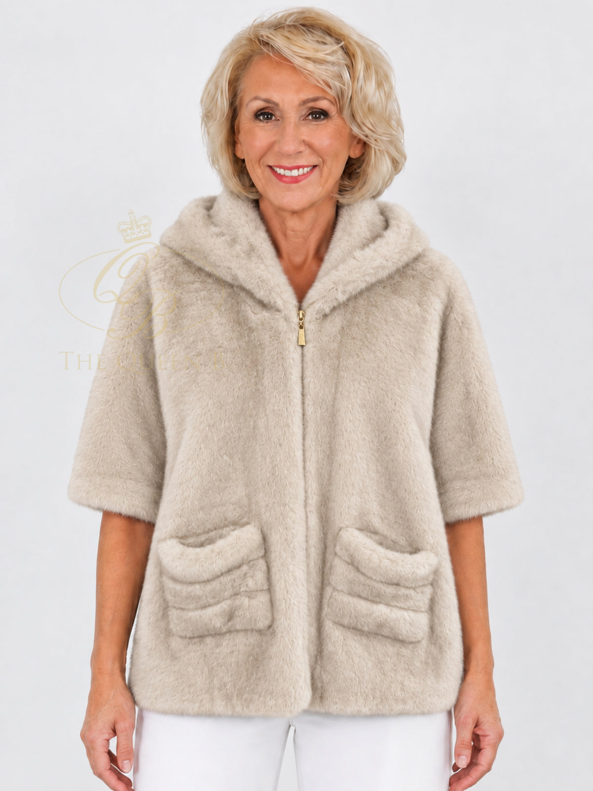 Micha 242 Cape with a soft textured finish, hooded design, zip front fastening, short sleeves and front pockets.
